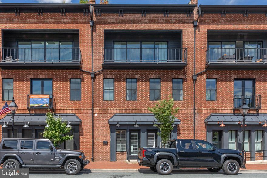 Fronting one of the most vibrant streets in the heart of Downtown Fredericksburg, this luxurious modern build offers over 5,000 square feet with all four levels accessible by private elevator. The versatile first level, currently built out as a one bedroom apartment with full kitchen can be used as a separate apartment or transitioned back into commercial space. The second level’s open concept living features trayed ceilings, wainscotting and beautiful hardwood floors.  The gourmet kitchen with island and seating features Wolfe and Sub Zero appliances, upgraded cabinets and quartz countertops.  Just beyond the kitchen are two bedrooms, one currently used as an office space, and a balcony complete with gas line for convenient outdoor grilling. The third level offers three more bedrooms and three full bathrooms. The primary with en suite offers a second balcony overlooking William Street.  The fourth level takes you by elevator to the rooftop deck.  Engineered to hold a hot tub or small pool, the deck is spacious with spectacular 360 degree views of Downtown.  Situated on Downtown's "restaurant row" and steps away from local favorites like Sedona Taphouse, Blue Cow Ice Cream, and V Chophouse, this home is at the heart of Fredericksburg's vibrant scene. Enjoy the convenience of a park across the street and the charm of a walkable neighborhood. Masterfully built with brick and embodying modern elegance, this home stands apart, providing a fresh and luxurious lifestyle. Whether you're entertaining guests or enjoying a private perch over FXBG, this exceptional property offers an unmatched living experience. Don’t miss out on this unique, one-of-a-kind home.