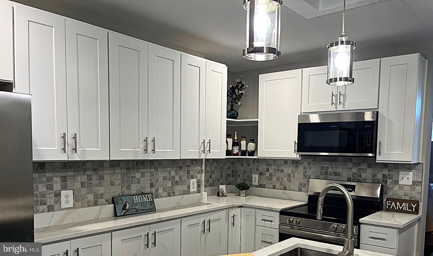 Nestled in the heart of the vibrant Remington community is this beautiful 2 bedroom, 2 1/2 bath turn-key home.  Combining the old charm of early 1900's architecture and today's modern conveniences, this fully renovated row home will meet or exceed all your expectations.  This complete rehab includes all new mechanicals - new plumbing, electrical wiring and systems, and new HVAC system.  The main level is a mostly open floor plan featuring a foyer that boasts two entry doors, a living room with a modern glass crystal fireplace (heater function as well), exposed brick, recessed lighting, and large front windows. An archway takes you into the modern kitchen with all new soft close shaker cabinets, quartz countertops, stainless appliances, tile backsplash, large island, and a stunning ceiling feature with sparking pendant lights.  A dining area and powder room finish the main level.  The large rear patio is a great area for entertaining or can easily be converted into a parking pad for a small vehicle. Heading upstairs by way of the 1920 staircase lit by a large modern chandelier we find two generously sized bedrooms and two full bathrooms with ceramic tile, beautiful, good- sized vanities and modern fixtures.  The full-size modern laundry units are conveniently located on this level.
The basement has a bonus room that can be used for an office or playroom.  The remaining lower level is clean and dry and supports the new furnace and water heater.  Plenty of storage is available. The contractor went all in on this home and all work is to code and permitted.  This home truly is a gem and will allow worry free living for many years as Remington continues to grow and prosper.  Also, Johns Hopkins offer grants up to $10,000 for this area as part of their Live Near your Work (LNW) program.
Remington has parks, playgrounds, many restaurants, running/walking trails, and a very active community association.  Nearby is Johns Hopkins University and the Baltimore Museum of Art.  Route 83 is a minute drive away.  Come take a look today - this one won't last long!