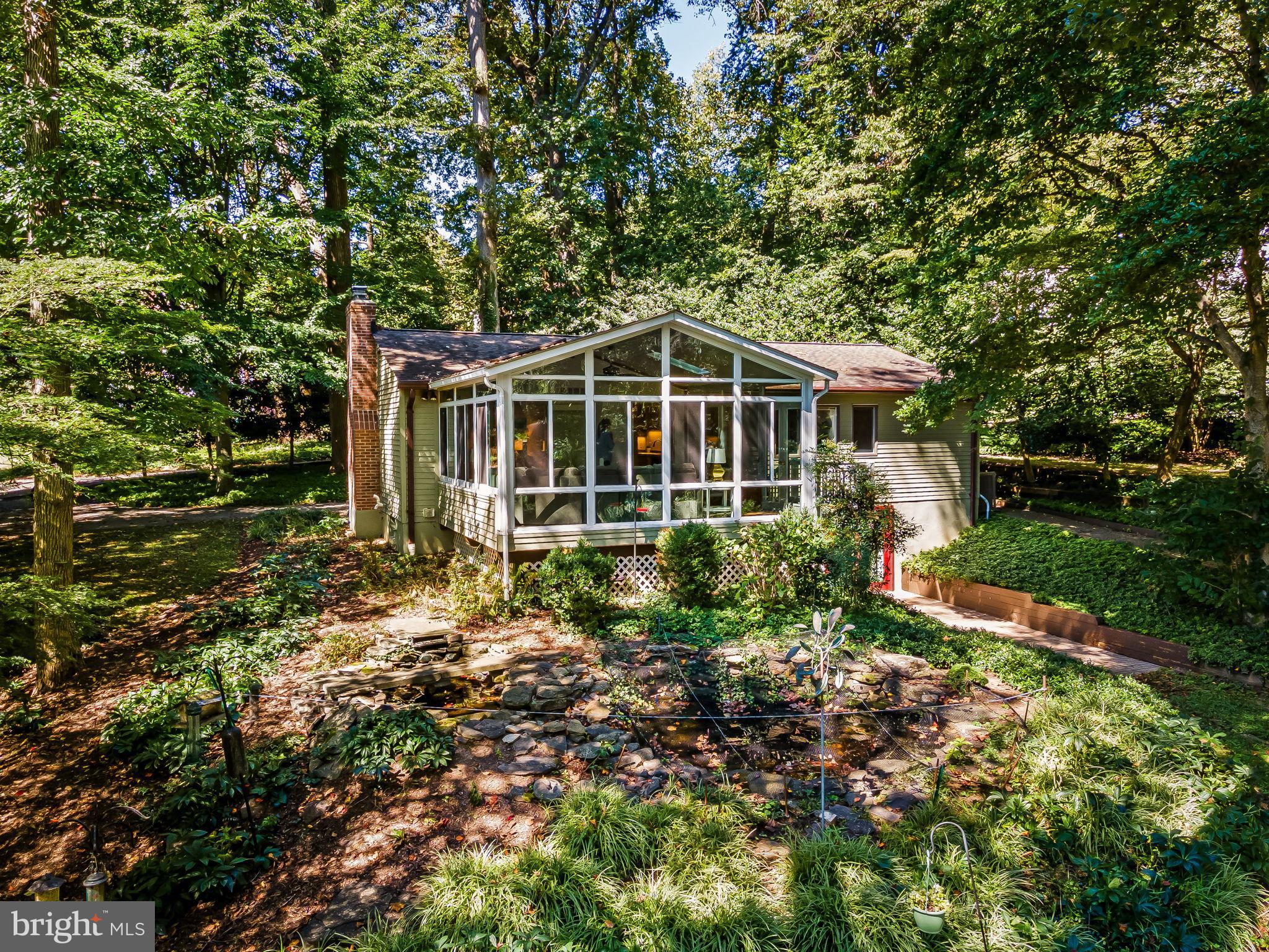 Welcome to 8531 Hill Spring Drive, in the conveniently located and sought-after community of Hillside at Seminary. Set upon an oversized, private and secluded lot - surrounded by trees and lush landscaping - this peaceful enclave is a welcome retreat from the busy lives we lead. You'll cherish and look forward to your time spent in the stunning solarium main floor addition, with floor to ceiling windows and breathtaking views of the three-quarter acre lot - a magical backdrop for a charming koi pond and abundant wildlife. Comfort and Calm are the perfect words to describe the home, where you'll feel like you've truly gotten away from it all - without going anywhere at all. Three entry-level bedrooms and two full baths are located on the main floor. In the walk-out finished lower level, the large open space is perfectly suited for use as a living, exercise, or media room. A separate storage / workshop space will come in handy for working on projects, and stowing gardening tools and holiday decor. Additionally, there is a possible office or fourth bedroom plus another full bathroom on the lower level. Use this space for guests, teenagers, or caregivers - its versatility is a true benefit of the layout of the home. You're just a hop, skip and a jump to Greenspring Station for meals out or doctor's appointments, minutes away from Meadowood Park to play with the kids or dogs, a short jaunt to nearby schools, plus easy access to major thoroughfares to get you anywhere you need to be. A newly added full house generator provides security, and worry free living. A very special home in Lutherville, at just the right time for you. Welcome home.