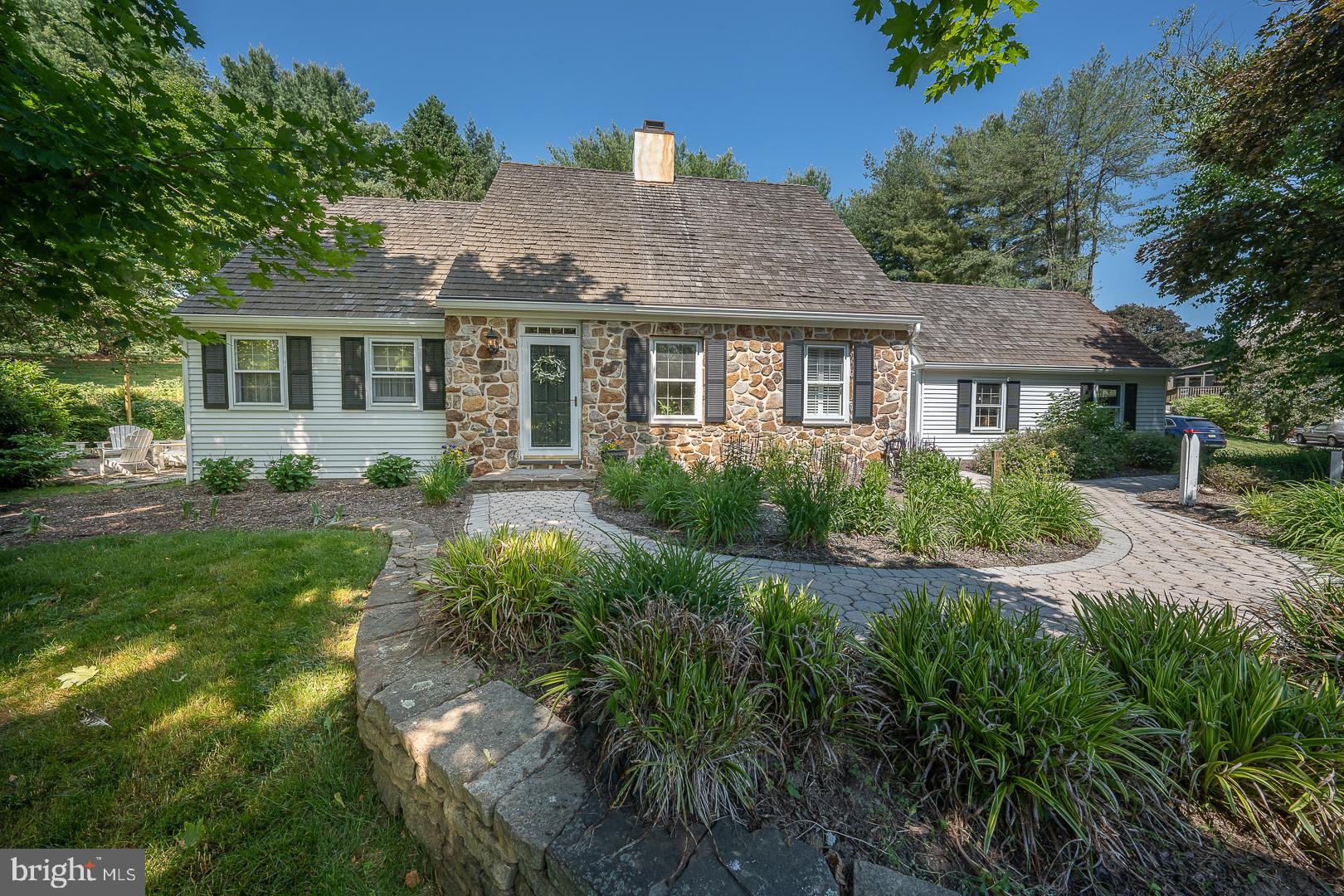 Hurry up and make your appointment to see this lovely large Cape Cod with a newly remodeled first floor main bedroom and full bath on 1 acre just outside of downtown West Chester. This is a unique looking home which stands at the forefront of a quiet desirable neighborhood. Although listed as a 3 BR home, there is bonus room that is currently being used as a home office which could easily be converted into a fourth bedroom. The first things you will notice about this house are the stunning setting and fantastic location for its proximity to the WC borough. The well planned landscaping, patio and gardens overlook a lovely (neighbor's) pond and feels so rural and yet is only a 15 min walk from downtown West Chester with all of its boutiques, restaurants and arts. You can walk the dog into town and still be just a short drive to Stroud's Preserve! The "made for entertaining" outdoor oasis features a pollinator garden, stone steps, decorative lighting, household propane hookup and highlights a custom made stone boulder, gas firepit.
Other great features include a newly remodeled first floor main bedroom and bath, refinished hardwood floors, large dining room for big family events and a cozy family room highlighted by big windows and two newer sliding glass doors. The kitchen has large cherry cabinets, granite countertops and stainless steel appliances. There is also and a half bath on the first floor for guests to use when hosting. Upstairs you'll find refinished hardwood stairs, luxury vinyl flooring for 2 bedrooms, a bedroom/office/nursery and a full bath. All of this sits on a perfectly manicured, 1 acre lot protected by mature shade trees.
Recently updated systems include the furnace, A/C, gutters, garage door and driveway.