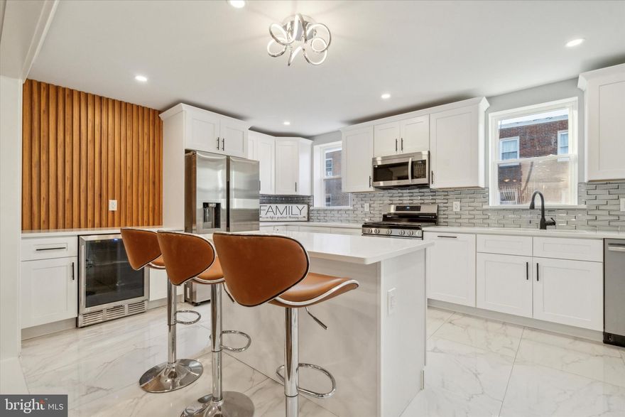 Welcome to 1311 Yerkes Street, located in Mt Airy—a meticulously renovated 3-bedroom, 3-bathroom home that showcases quality and custom craftsmanship throughout. The front and surrounding walls of the home has undergone an exquisite stone restoration, with careful repointing to restore the beauty of the original stone, giving it a clean and sharp appearance that enhances its curb appeal. From the moment you enter, the open floor plan creates a sense of space and flow, with double-entry access to the front and back of the home adding extra convenience and charm. The heart of this home is the expansive kitchen, a perfect blend of functionality and elegance. It features ample counter space, beautifully crafted cabinetry, and a ceramic-tiled floor for easy maintenance. A stunning wet/dry bar with a beverage refrigerator, accented with a warm wood backdrop, adds character and style, making it an ideal space for entertaining. The kitchen is also equipped with brand-new stainless steel appliances, including a gas range, oven, dishwasher, refrigerator, and microwave.Throughout the home, brand new hardwood floors are complemented by LED recessed lighting and ceiling fans, bringing both luxury and comfort to each room. The upper level features three spacious bedrooms, including two well-sized bedrooms and a primary suite complete with an en-suite bath, LED mirror, shower stall with sliding glass doors, and double closets. The hall bath includes a double vanity and a glass-enclosed tub for a spa-like experience. Every room shines with natural light, and the brand-new wood staircase adds a touch of elegance to the open layout. The fully finished basement, complete with a full bath with a sliding glass shower door, washer, dryer, and garage access, serves as a versatile space for guests or recreation. With a one-car garage, driveway parking, and additional street parking, you’ll have plenty of options for vehicles. You will not be disappointed with this beautiful home and move in with a peace of mind with all new systems including HVAC (central heat and air system), plumbing and electrical work! Schedule your showing today!