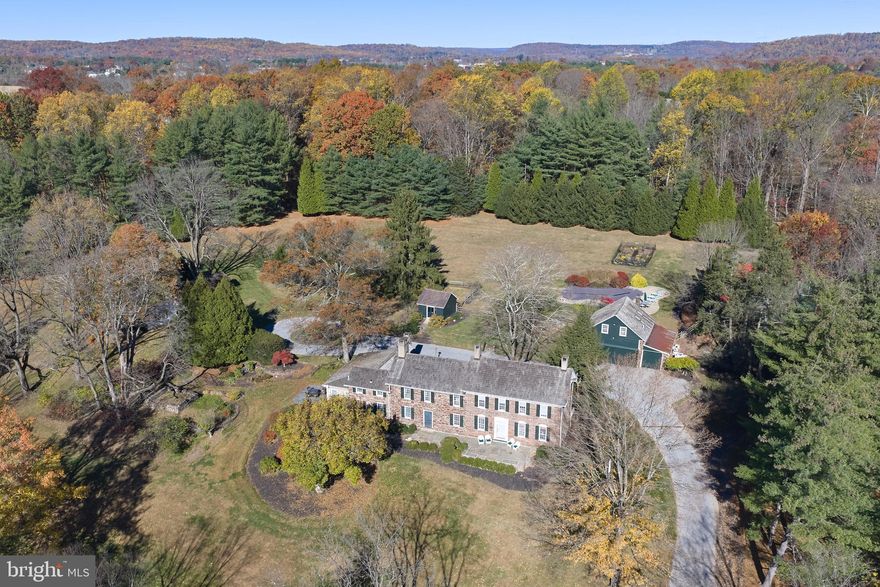 Residing in prestigious Upper Makefield, this idyllic luxury estate is a lesson in extraordinary living. Built in the year 1752, this remarkable estate holds a distinguished place on the National Register of Historic Places and historically functioned as a medical facility for the troops of George Washington during the Revolutionary War. Nestled in a serene setting, the property includes a charming two-bedroom carriage house, a picturesque natural swimming pool that enhances the landscape, and a tennis court perfect for leisurely pursuits. An architectural masterpiece, the stately farmhouse hosts an awe inspiring sun-drenched great room with a library, vaulted ceilings and gas fireplace. A custom William Draper kitchen, rich wide-plank floors, exposed beams, custom millwork and six noble fireplaces also grace this extraordinary home. Additionally, the original bank-barn has been cleverly transformed to serve dual purposes as both a pool house and a garage. Surrounded by vibrant gardens, sturdy trees, and a sprawling meadow, this residence offers an enchanting blend of historical importance and natural charm. 
Washington Crossing State Park, where Washington crossed the Delaware in 1776, is just a mile away and offers access to the renowned 58.89 mile canal tow-path, is home to the iconic narrow metal bridge, scenic views along the lake and beautiful trails for hiking, trail running and biking, as well as a museum and historical sites.
Exceedingly private yet conveniently located near New Hope Borough—known for its riverside dining and theater experiences, this estate is also near major cities such as Philadelphia, Princeton, and New York City; making it ideal for commuters and urban lifestyles. 1789 Wrightstown Road represents the perfect fusion of Bucks County’s cultured elegance and modern luxury.