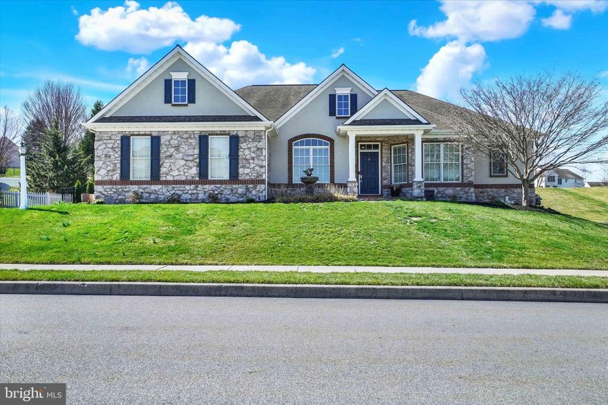 This stunning custom-built home offers the perfect blend of elegance, comfort, and thoughtful updates, all set in a desirable Dallastown neighborhood and school disctrict.  From the moment you arrive, the curb appeal and inviting layout set the tone for what’s inside—an open, light-filled floor plan accented by newly refinished hardwood floors in a rich barrel oak stain. The spacious foyer welcomes you into formal living and dining areas featuring 9' tray ceilings, wainscoting, and timeless architectural details such as arched doorways, double crown molding, and custom built-ins. Entertaining is effortless with a convenient butler’s pantry leading into the well-appointed kitchen, complete with granite countertops, stainless steel appliances, and a cozy dining area that flows seamlessly into the family room with gas fireplace and surround sound wiring.   The primary suite is a true retreat, featuring dual walk-in closets and a luxurious bath with a walk-in marble shower and double vanity. Two additional bedrooms, a remodeled hall bath with marble tile, a half bath, and main-level laundry complete the home’s easy one-floor living.  A bright sunroom with cathedral ceilings offers the perfect place to relax while overlooking the beautifully landscaped rear yard. Step outside to your own private oasis—featuring a saltwater pool, installed in 2021, a fenced yard, paver walkway leading to a Sundek patio and extensive hardscaping with a fireplace and a tranquil pondless waterfall—ideal for relaxing or entertaining all summer long.  Additional highlights include a new HVAC system (2025), active radon mitigation system, full unfinished basement offering endless possibilities, and a two-car garage. This home truly has it all—style, space, and updates in a fantastic location. Schedule your private tour today!