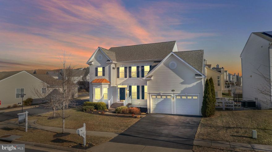 Where scenic mountain views meet thoughtful design, this upgraded Lake Point Colonial delivers standout comfort, versatility, and a setting that captures the natural beauty of Round Hill. Positioned on a premium corner lot along the Palisade, the home offers immediate access to neighborhood sidewalks, mature landscaping, and the peaceful outdoor atmosphere western Loudoun is known for.

A two-story, light-filled foyer welcomes you with an open and inviting feel. Just off the entry, French doors lead to a flexible room perfect for work, reading, or a quiet sitting space. Across the hall, the dining room offers generous wall space for statement furniture and flows easily toward the main living areas.

The heart of the home is the spacious family room, highlighted by a wood-burning fireplace and custom built-ins, including a unique hidden feature that enhances both charm and organization. This space opens directly to the granite kitchen, which offers an island, built-in desk area, ample countertop space, and a bright breakfast room with views of the backyard. Step outside to a fully fenced outdoor retreat featuring a large paver patio, an expansive pergola designed for optional privacy curtains, and low-maintenance landscaping that makes outdoor living enjoyable in every season.

Upstairs, the primary suite feels open and airy with its vaulted ceiling, two walk-in closets, and well-appointed bath with a soaking tub and separate shower. Three additional bedrooms and a full bath complete the upper level, offering adaptable space for guests, work, or hobbies.

The lower level expands the home’s functionality even further. A large recreation room includes a wet bar and wiring for a ceiling-mounted projector—perfect for media, entertaining, or creative use. The standout feature is the separate-entry efficiency-style suite with a private bedroom and full bath. This flexible layout supports a variety of needs, offering privacy and independence while remaining connected to the main home.

The 2-car garage is thoughtfully upgraded with heavy-duty overhead storage, a custom workbench, and built-in shelving designed to keep belongings organized without sacrificing parking space. Additional features include an exterior generator connection and recent improvements such as updated flooring and fresh paint throughout much of the home.

Lake Point offers a serene residential setting surrounded by nature, with nearby access to Sleeter Lake, Franklin Park, local wineries, and Round Hill’s charming town center. Commuters benefit from quick connections to Route 7 and proximity to Purcellville, Leesburg, and major commuting routes. Shops, restaurants, and everyday conveniences are moments away, giving this location the ideal blend of tranquility and practicality.

With its spacious interior, well-designed outdoor areas, and rare lower-level private suite, this property offers versatility that aligns with today’s lifestyle needs. Beautifully maintained and thoughtfully improved, it presents a compelling opportunity in one of Round Hill’s most desirable communities.