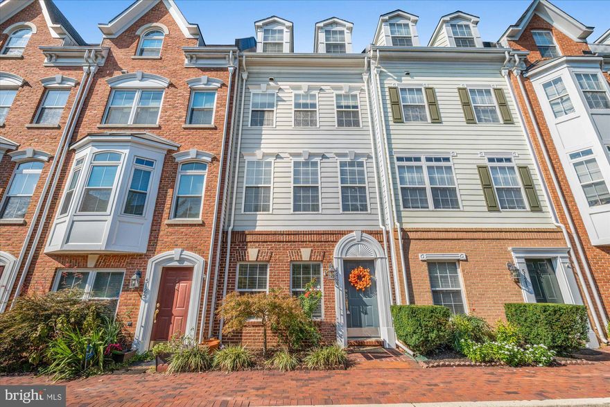 Beautifully updated Jackson model boasts four above-grade levels, showcasing light hardwood floors in the living room, lower level, and stairs. The primary bath has been remodeled, the kitchen features granite countertops and stainless steel appliances to include a brand new Samsung refrigerator. An adjacent dining room area provides seamless access to a charming small deck, while the living room features a cozy gas fireplace. The full-floor primary suite offers a spa-like bath and a custom organized walk-in closet. On the top level, you'll find two spacious bedrooms, one of which is open to the stairs but can easily be enclosed with drywall and a door. Additional amenities include a one-car garage, extra covered parking space with a storage room, and access to the fantastic Cameron Station amenities.