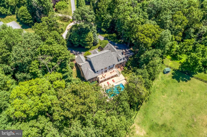 Remarkably refinished with the utmost style -- the perfect blend of solid architectural features with current design elements in a coveted location between the Caves and Greenspring Valleys.  Located in a small gated community of custom homes, this property is sited on a culdesac with privacy and a beautiful heated salt water pool.   Be wowed by the soaring ceilings and fresh surfaces -- the entire home has been thoughtfully updated  and designed with fresh paint, newly finished floors, remodeled kitchen, reconfigured design elements, and upscale lighting design by Jones Lighting.  Resort style feel in a well functioning home.  The recent renovations (2020-2021) are exactly what today's buyers are wishing for including multiple spaces for family to do work, play and relax.  Multiple bedrooms with ensuites on different floors offer privacy and places to get away.   Off of the pool is a light filled home gym and recreation room perfect for birthday parties, game watching and overnight guests.   Enjoy cold nights near one of the four fireplaces or take a peaceful morning swim in your heated pool...Relax your muscles in your own dry sauna, or cook a new recipe in the gourmet kitchen or gasfired grill overlooking the pool.  Feel confident in buying a house well maintained and beautifully updated -- this property is a 10 on a scale from 1-10.    Move right in and enjoy the luxury of enjoying every aspect of this wonderful home today.   A true gem in a super convenient location close to shopping, golf courses, public and independent schools just minutes away.