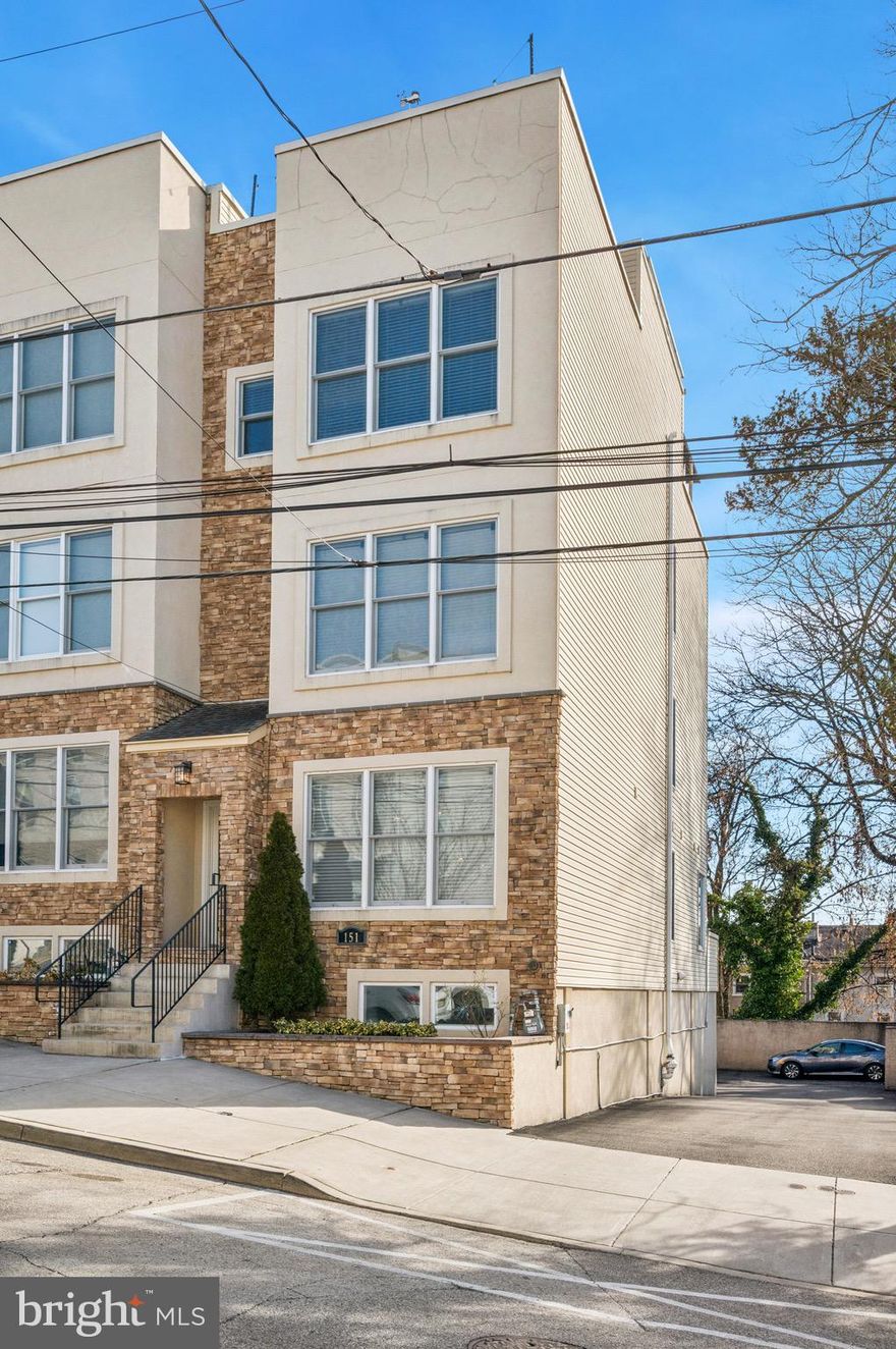 Modern Luxury in the Heart of Manayunk

Don’t miss the opportunity to call this stunning end-of-row townhouse home. Built in 2016 and meticulously maintained, this residence shows like new and offers the perfect blend of modern design, thoughtful upgrades, and an unbeatable location just steps from vibrant Main Street.

Enter into a bright, open-concept living and kitchen area designed for both everyday living and effortless entertaining. The home features bamboo hardwood flooring and 9-foot ceilings throughout, creating a warm and airy atmosphere.

The beautifully appointed kitchen showcases crisp white shaker cabinetry with soft-close doors and drawers, updated hardware, and abundant storage space. Sleek quartz countertops are complemented by a striking mosaic tile backsplash and stainless steel appliances, including a gas range, built-in microwave, and French-door refrigerator. The oversized island provides additional prep space, seating, and a deep undermount sink with a statement gooseneck faucet. Recessed lighting and pendant fixtures complete this well-designed space.

Just beyond the kitchen, a private dining room features oversized sliding glass doors leading to the rear deck — perfect for seamless indoor/outdoor entertaining. A powder room and spacious pantry complete the main level.

Second Floor – Comfort & Convenience
Two generously sized bedrooms each offer private en-suite bathrooms and ample closet space. A hall laundry room adds everyday convenience with a sink, cabinetry, and a folding counter.

Third Floor – Owner’s Retreat
The expansive primary suite features 9+ foot ceilings, two walk-in closets, and a sitting area with a skylight, currently used as a home office. The spa-inspired primary bath is designed for relaxation and refinement, offering a freestanding soaking tub, transom windows for natural light and privacy, and a modern double vanity with dual sinks and quartz countertops. A full wall mirror enhances the sense of space, while elegant lighting, an oversized glass-enclosed shower, and a private water closet complete this luxurious retreat.

Top-Level Entertaining
A wet bar leads to an impressive multi-level rooftop deck — ideal for relaxing evenings or hosting guests while enjoying beautiful views.
Finished Lower Level
The spacious finished basement provides additional living space, a half bath, and direct access to the one-car garage.
Recent Owner Upgrades Include:
6.8kW Solar System (offsets annual electric usage)
Nest Thermostats
Radon Mitigation System
Full Ring Security System (alarm and cameras)
Motorized Blinds
Roof decking, turf, and landscaping planters
Kitchen cabinet and hardware upgrades
Fresh paint in living room and basement
Updated lighting and ceiling fans
Garage painted with added storage racks
NEMA 14-50 EV charging outlet
This exceptional home checks every box — location, luxury, parking, and modern efficiency — all just steps from Main Street dining, shopping, and entertainment in Manayunk. Conveniently located to major roads, center city, and the suburbs.  Home is located on the famous  Bike race route coming back to Philly in August 2026.