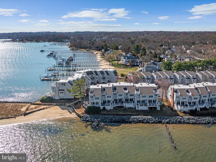 Stunning views of the Magothy River in the beautiful gated community of Moorings on the Magothy. There is no better view anywhere! The street side of this four story townhome features a one car garage with additional storage and elegant brick entry. The front entry brings you to a contemporary, open staircase with hardwood floors. The first living level features a classic, eat-in kitchen with stainless steel appliances, granite counters and pass-through to the elegant dining room with wet bar. The dining room over-looks the step down living area with stone fireplace featuring a pellet stove and high, coffered ceiling.  The 15FT slider opens to the 17x10 composite deck with tempered glass baluster, so as not to impede the view.  On the second floor, when entering the master bedroom with a vaulted ceiling there is a wall of windows to see the spectacular sunsets. The master bath features custom, 6 ft tiles, double head shower and double vanity. On this level there is an additional bedroom with ensuite bath. On the top floor, a large multi-use area can be used as an additional bedroom or sitting area, or both and a full bath. There is an additional 14x9 balcony with unparalleled views up and down the river. Noteworthy additional features are, custom trim including wainscoting and chair rail, replaced sky lights, new roof, storage area in the back of the garage with french drain, cedar closets in the garage, storage area under the deck, new water heater and large windows with tons of natural light throughout. 
Moorings on the Magothy neighborhood features a new gated, stone entry, tennis courts, walking path with community lawn area for picnics and gatherings, a large strolling and swimming pier that you can dock your boat for the day and a community beach with roped off swimming area. Only a few blocks from Magothy Marina and The Point restaurant. The condo association has been revitalizing the neighborhood. All of the units have new roofs, the trees and landscaping are being refreshed, the main entrance was updated, the bulkhead has been replaced with rock (never needing replacement again) and the community pier was rebuilt. 
****A new reserve study has been budgeted for in the fall of 2025. The condo fee currently reflects the condo fee $575/month and the special assessment fee $625/month that was for the bulkhead. The bulkhead has been completed and 2025 would have been the last year of the special assessment. The association is doing the reserve study to reduce the condo fee in 2026.
****Seller has an assumable VA loan at 2.25%. Loan is assumable by buyer who qualifies for a VA loan.