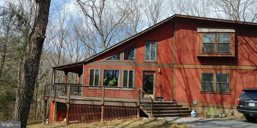 Contemporary single family home located on a private 5 acre wooded lot. Interior balcony overlooks spacious living room. Large wrap-around porch. Living room features wood burning stove. Three bedrooms, one located on main level and finished basementHome is professionally managed