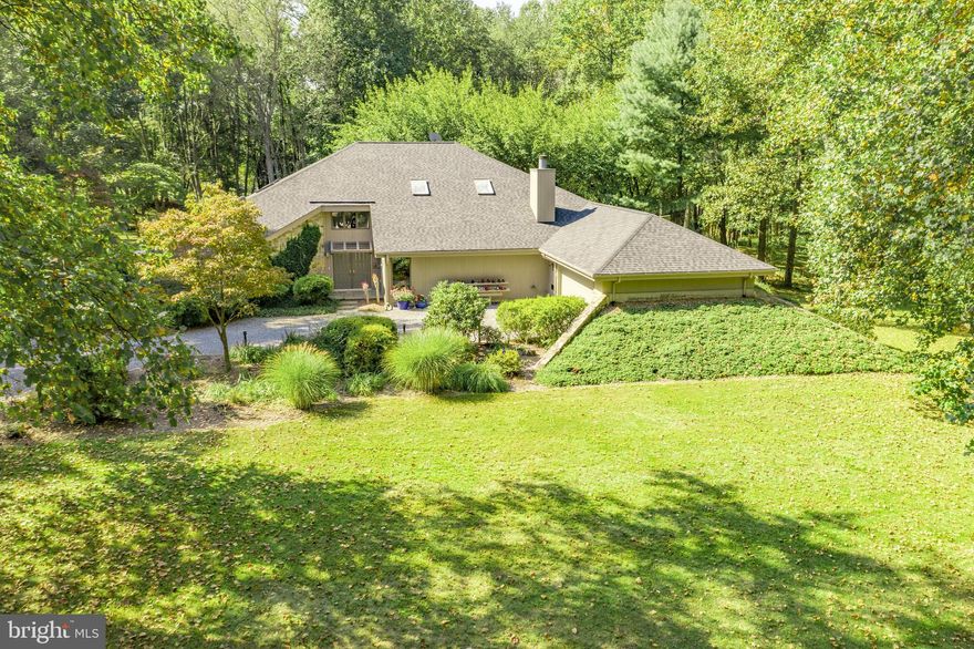 Sold with Multiple Offers: Spectacular, spacious, architect-designed custom-built Contemporary with clear western red cedar and natural stone exterior located on 6 partially wooded acres providing resort-like atmosphere in total privacy.  MAIN FLOOR features Master Bedroom suite with two full bathrooms, high ceilings, walk in closet/dressing room, and an adjoining 3-season SUNROOM; Large LIGHT-filled GREAT ROOM with new skylights and double-sided wood burning fireplace between Great Room and adjoining Family/Media room;  Enormous eat in Kitchen with two islands, pantry, china closet, GE Profile double wall ovens & dishwasher, Amana refrigerator;  separate Dining Room with built in shelves and custom rolling buffet;  Excellent Laundry room; and Powder Room.  Bedroom, Sunroom, Kitchen, and Dining Room all open out onto DECK with AMAZING VIEWS; and a 2-car Garage with storage closets and overhead storage space. Opening off the Main Floor Foyer is a 700 square foot fully insulated Workshop that could be converted to home gym.  SECOND FLOOR: features another Master Bedroom suite with full bath, BALCONY, built-in shelves; a large Bedroom with adjoining full bath, and an adjoining Big Bonus Room which could be used as a Bedroom, Playroom or Office; an Office/Study; and a Gallery Hallway lined with shelves overlooking the Great Room.  OUTSIDE features large DECK, 16ft x 40ft SWIMMING POOL, BBQ gas grill,  Dry Bar with mini refrigerator, outdoor speakers and lighting. GROUNDS include Clay Wood-Burning Oven and a TENNIS COURT sold  as is ; several OUTBUILDINGS including Utility and Garden sheds and Carport; and a large 2 level insulated building with attached 2-car garage.  RECENT UPDATES: ROOF 2017; exterior painting of House and Outbuildings in 2018; Well Holding Tank 2018; Heat Pump 2019; Skylights 2020; REFINISHED OAK FLOORS 2020.  **EXCEPTIONAL CONSTRUCTION with 2 x 6s not 2x 4s**, giving greater insulation. Furthermore, the berms provide retention of heat in winter and cool in summer. Thermal glass windows & mostly shaded during high sun elevations. It's impossible to overstate how BEAUTIFUL this property is. Original Owners just planted 70,000 wildflower seeds in garden. No Community/HOA fees.  Property to the rear is subject to an easement that prohibits additional development. Appraiser measures SQUARE FEET 3984 above ground without the workshop**(tax record is incorrect) Buyers must always verify the schools due to redistricting