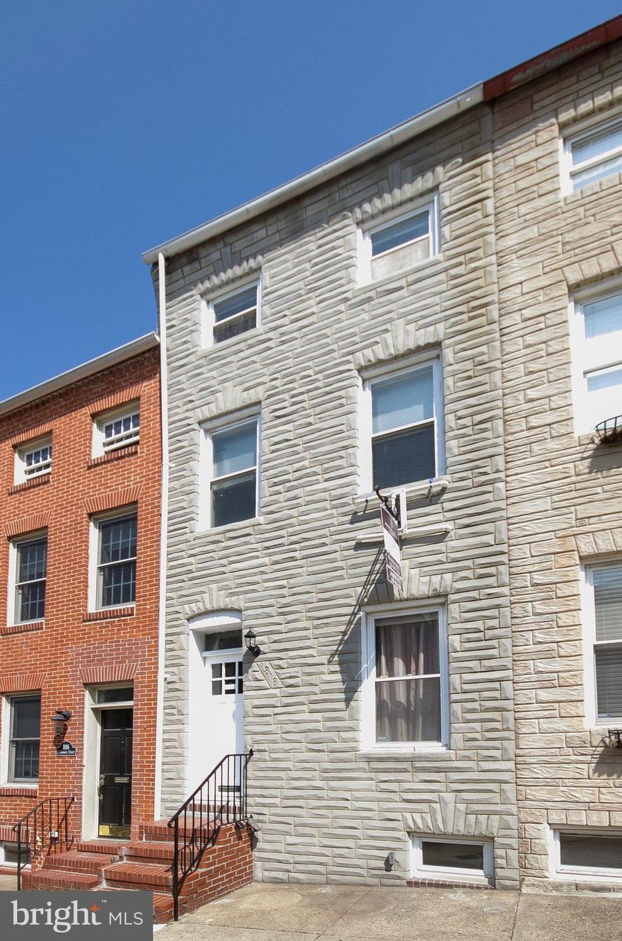 Don't let the formstone fool you. This large townhome was renovated in  2004. It features a massive double living room plus a unique dining/breakfast room leading to an enclosed green courtyard. The flooring consists of the original random width pine plus slate flooring in the dining and kitchen areas. The rooms are all of good size and updated master suite encompasses the entire third floor.