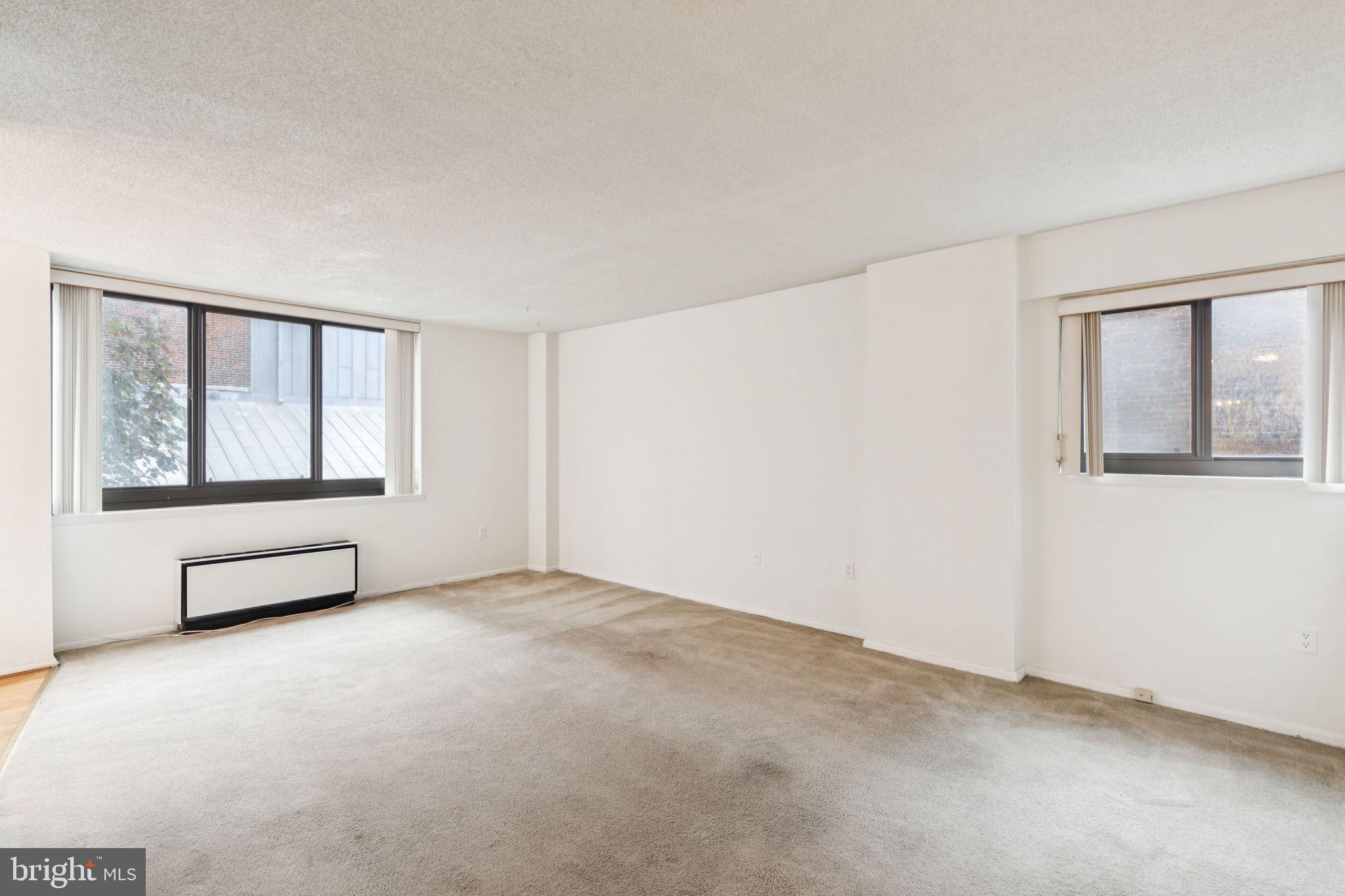 Two bedroom, one and a half bathroom with northeast city views at Academy House. Enter through a foyer with coat closet into the great room with oversized windows, large living space, and separate dining area perfect for entertaining. The generously sized kitchen features ample white cabinetry, dark granite countertops, and white appliances. Both bedrooms enjoy excellent natural light and nice sized wall closets. Adjacent to the primary bedroom is a full hall bathroom with tub shower and stacked washer/dryer. There is a powder room with large single vanity, conveniently located across from the second bedroom. The hallway, kitchen, dining area, second bedroom, and powder room enjoy hardwood floors. Residents of Academy House enjoy a 24-hour doorman and a state-of-the-art fitness and aquatic center. There is valet parking in the building's garage for an additional monthly fee, subject to availability. The Academy House is located in the heart of Center City and within close walking distance to Rittenhouse Square, Washington Square, and the Broad Street and Market Street office corridors. The Philadelphia International Airport and Amtrak's 30th Street Station are easily accessible.