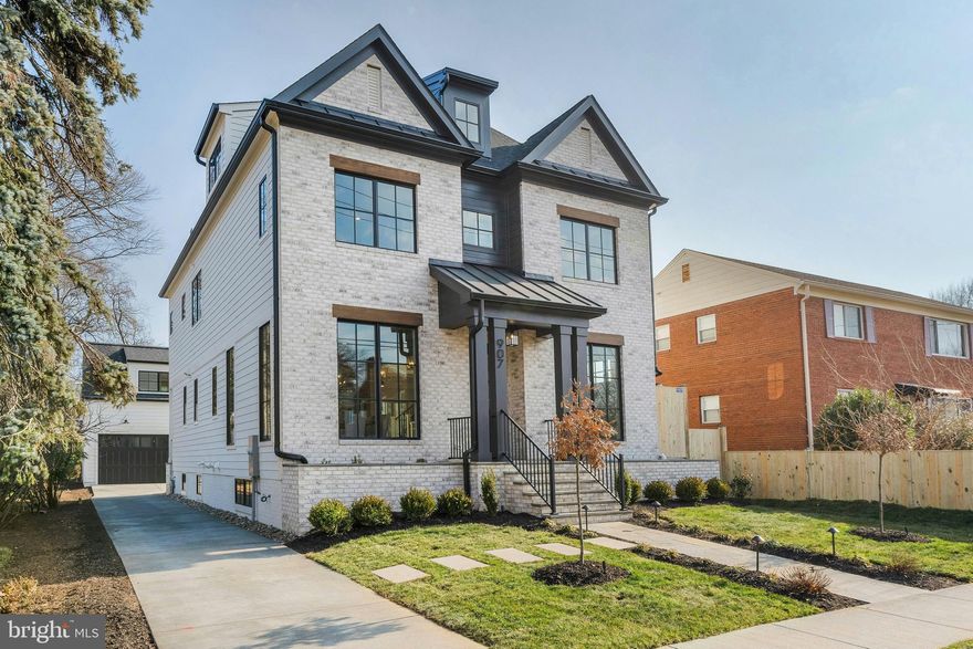 Modern Luxury Meets Timeless Craftsmanship in the Heart of Clarendon
📍 Clarendon | 🛏 6 Bedrooms + Studio bedroom | 🛁 6.5 Baths | 📐 Approx. 6,025 Sq Ft | 🚗 Detached 2-Car Garage w/ ADU |  New Construction

Welcome to your dream home nestled on a picturesque  lot in the heart of Clarendon, one of Arlington's most sought-after neighborhoods. This brand-new construction blends classic elegance with contemporary design across four beautifully finished levels—plus a separate studio suite above the garage—offering the perfect balance of space, sophistication, and smart functionality.

Exceptional Exterior Details:
Crafted with James Hardie smooth siding, a brick front veneer, and Tamko architectural shingles, the home is as durable as it is stunning. Step up to the flagstone front porch, admire the professionally landscaped grounds, and enjoy peaceful evenings on the rear screened porch featuring ceiling heaters, speakers, and a gas line ready for your grill. The two-car detached garage includes a fully finished studio/office ADU with a rough-in for a 240V EV charger—ideal for guests, rental income, or remote work.

Light-Filled Living Spaces:
Inside, soaring 10' ceilings on the main level and 9' ceilings upstairs create an airy, open feel. The gourmet kitchen is a chef’s delight, with custom inset maple cabinetry, Quartz countertops, and top-of-the-line appliances including a 48” Wolf gas range and Sub-Zero fridge. Entertain in style with a butler’s pantry, large center island, and breakfast nook that flows seamlessly into the family room with a 48” linear gas fireplace and ceiling beams.

Thoughtful Floor Plan:
With 6 bedrooms, 6 full baths in the main house, and a powder room, this home was designed with flexibility and comfort in mind. The first floor features a private library with built-ins, formal dining, and a mudroom with custom cubbies. Upstairs, the luxurious primary suite includes a tray ceiling, spa-like bathroom with heated floors, soaking tub, frameless glass shower, and a massive walk-in closet. The second floor also hosts a laundry room with a sink and three more bedrooms—including a Jack & Jill layout and one en-suite.

The 3rd-floor loft offers additional living space with a wet bar, bedroom, and full bath—perfect for multi-generational living, guests, or play space.

Lower Level Retreat:
The expansive finished basement includes a rec room with a wet bar, exercise room, in-law suite, and a finished storage room. The flooring throughout is both beautiful and practical: White Oak hardwoods, luxury vinyl tile, rubber gym flooring, and premium carpeting.

High-End Systems & Smart Features:
Built with energy efficiency in mind, the home includes Andersen 400 Series windows, upgraded insulation (R-49 attic, R-15 walls), a ProLine XE 75-gallon water heater, and zoned Carrier HVAC with Aprilaire air filtration and humidifier. Tech-savvy buyers will appreciate CAT6/RG6 wiring, Ecobee doorbell camera, built-in ceiling speakers in key rooms, and 400-amp electric service.

Built by the Trusted 3rd Generation Builder, MR Custom Homes, this property comes with a full 1-year warranty, plus structured pre-settlement walkthroughs and service appointments for your peace of mind.

📞 Don't miss this rare opportunity to own a true showpiece in Clarendon. Schedule your consultation today to discuss finishes and experience the unmatched quality and comfort of your forever home.

Home is completed and ready for its new owner.
