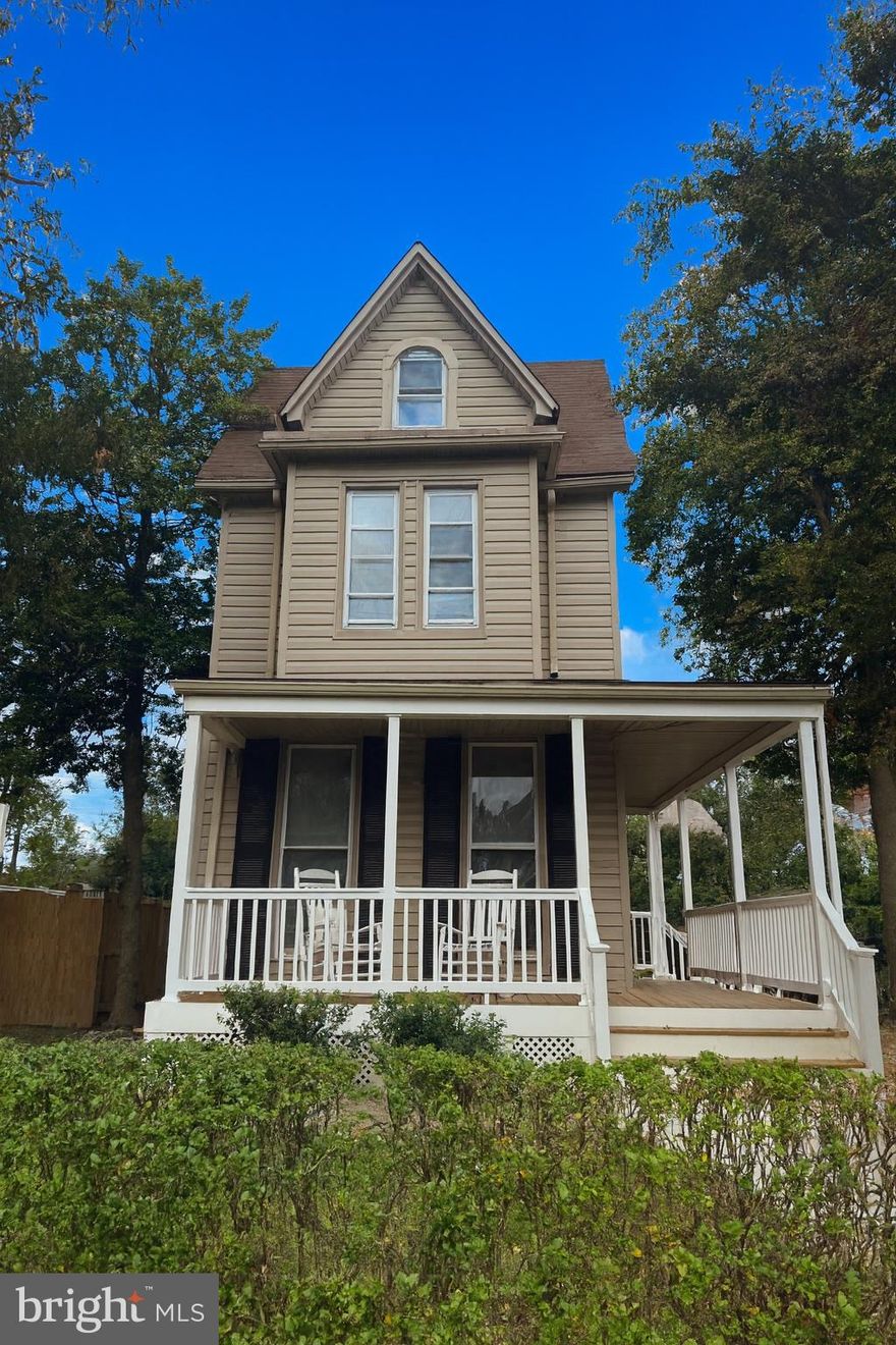 Built in 1900, this enchanting storybook Victorian is framed by mature trees and dappled light, welcoming you with its gracious wraparound porch—a perfect spot to sip cider and watch the leaves drift down on a cool autumn day. Step inside and feel the warmth of beautifully refinished original hardwood floors, tall ceilings, and the soft glow of stained-glass windows casting color across the living room’s original decorative fireplace and mantle.
The newly renovated kitchen blends classic style with modern comfort, featuring white Shaker cabinets, quartz counters, and generous prep space for cooking or gathering. The separate dining room invites memorable evenings—picture candles glowing, friends lingering over dessert, and conversation that carries late into the night.
Upstairs, you’ll find three inviting bedrooms, two full baths, and abundant closet space, plus a sunny third-floor bonus room that’s ideal for an art studio, home office, or peaceful hideaway—along with plenty of attic storage.
Out back, a deck opens to a wide, deep yard that’s perfect for cool fall evenings around a firepit. A wide driveway provides parking for up to four cars, and a spacious storage shed offers endless potential—whether you envision a workshop, potter’s shed, or future garage.
Steeped in character yet refreshed for modern living, this gracious Victorian invites you to begin its next chapter—with warmth, beauty, and charm at every turn.