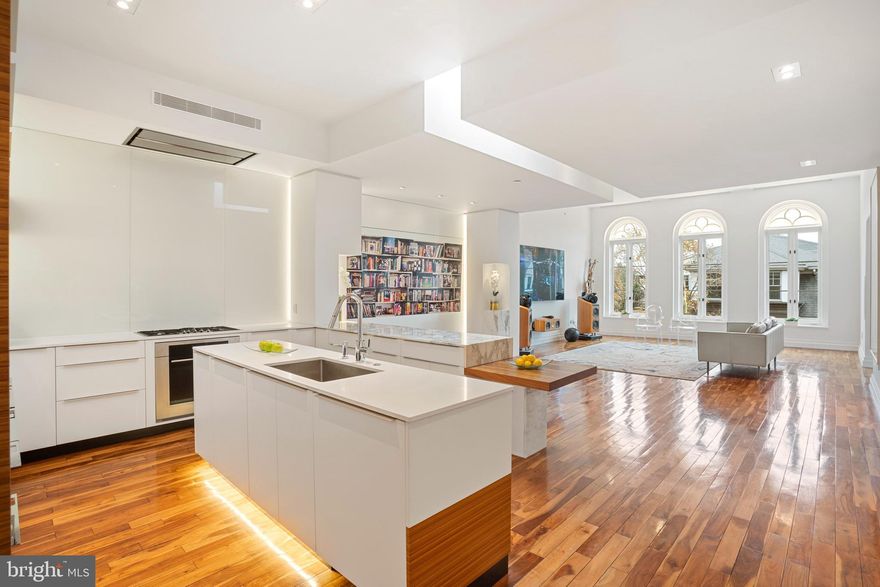 Stunning 3 bedroom, 3.5 bathroom top floor unit with two garage parking spaces in the prestigious Society Hill neighborhood of Philadelphia. No detail was spared in the renovation of this home, completed in 2015 and designed by renowned architect Cecil Baker. Enter directly from the elevator into the unit and be greeted by the vast living space and high ceilings of this large condo. Sleek hardwood floors, two gas fireplaces, Savant controlled surround sound and lighting, Lutron automatic shades, door intercom system, and skylights throughout are just a few fantastic features of this modern residence. The living space has tall landmark windows which allow for an abundance of natural light to beam into the home. Relax by watching your favorite shows on the 98" LG HD TV. The beautiful, open kitchen has Calacatta marble and stone countertops, under cabinet lighting, a glass backsplash, built-in Miele espresso machine, Wolf appliances, a Sub-Zero refrigerator, Miele wine refrigerator, and a hidden pantry. The lavish dining room has a gas fireplace and Juliet balcony overlooking 3rd Street, with access to a side bedroom/office space with a full ensuite bathroom. Down the hall is a half bathroom with a Robern sink vanity, an in-unit washer/dryer, and coat closet. Second bedroom is spacious with an alcove for gym equipment or bed. There is also a full ensuite bathroom, Robern vanity and walk-in closet. The massive primary suite has a Samsung 48" TV, custom headboard and Mitchell Gold bed with matching side tables, book shelves, 2 walk-in closets with custom built-ins, and a stunning ensuite primary bathroom with double sinks, Robern vanities, heated floors, multiple shower heads, a TV, and separate toilet area. There is a large stone balcony right off of the primary bedroom. Additional features include central air and heat, large storage unit in basement, trash room, self-managed building, plenty of outlets throughout, new water heaters, and a large shared garage with car lift. Unit also includes the roof rights. Located in the highly coveted Society Hill neighborhood steps from historic landmarks, museums, and plenty of dining options.