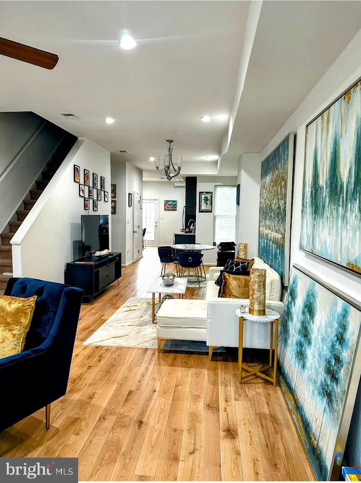 Discover this beautifully updated 4-bedroom, 3.5-bath brick rowhome just steps from Johns Hopkins University and Kennedy Krieger Institute. Boasting a spacious, open floorplan, the main level features such a light-filled dining area off an eat-in kitchen equipped with stainless steel appliances, 42" cabinetry, and direct access to a private deck and fenced in yard. The cozy livingroom with fireplace is both stunning and welcoming. Upstairs, you'll find a serene primary suite with an en-suite bath, plus two additional bedrooms with rich hardwood flooring and a well-appointed main bath. The walkout basement sets this property apart from the others -- fully finished with a separate bedroom, bath, living area, and kitchen—ideal for Airbnb, long-term rental income, or multi-generational living. With quick access to I-83, Downtown Baltimore, Fells Point, and more, this home is a rare opportunity to live comfortably while building equity and passive income.