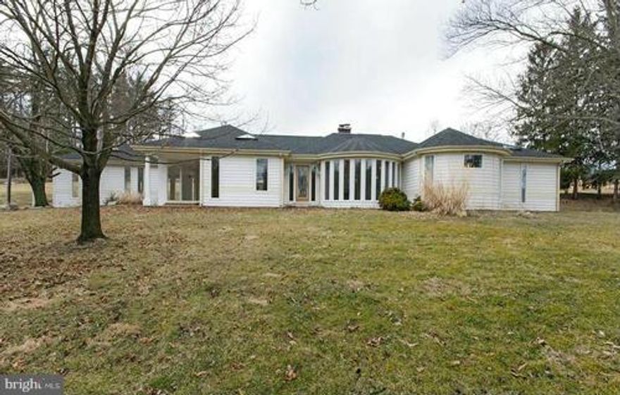 Modern Mid Century Rambler is a Must See! Completely rebuilt in 2008, Open floor plan, custom glass features including elliptical outer wall, marble FP. Lg. Master BR w/ Jacuzzi tub, Italian Marble Shower. Outdoor screened porch & kitchen. Full basement w/tiled FR, bath, storage. New A/C & HP. 2-3 carport, 2 porches & patio. State Road. 5.99 private acres.Pets case x case. Credit Report Required