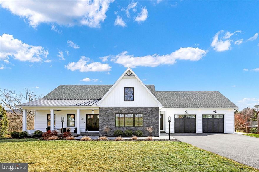 Spectacular views of the Founder's Course and Blue Ridge Mountains were an inspiration in the construction of this modern custom built home. Flooring throughout entire home is engineered wood. All windows and french doors are LowE3 Glass which reduces heat flow and blocks UV rays. Main level living space is an open concept for easy entertaining. Front entrance has a covered brick paver porch 25' x 8'. Living Room open to Dining Room shares a beautiful gas fireplace. Kitchen has abundant cabinetry with many special built-in features. Amazing twelve foot island with chairs. Corian countertops and backsplash in kitchens and baths. Covered upper balcony 45' x 10' with Azek decking boards and vinyl railing. Propane connection in two places on deck for fire pit and grill. Primary suite has french doors onto deck, attached private office, full bathroom with corian shower (no grout) with rainhead fixture, and walk-in closet with organizers. Second bedroom on main level is 18.6 x 12. Laundry room and half bath on main. Spacious garage with storage to the rear behind barn doors also with amazing views. Garage has drains and pull down attic access. Lower level could be additional living space or a Mother-in-law Suite. Extra wide staircase to lower level with separate entrance and electric for chairlift if needed. Door to lower level is not installed- it is in the storage area. Lower level includes a large Recreation Room open to Dining area and full Kitchen with Island and Appliances. French doors to rear covered Patio which is 45' x 10' with brick pavers. Third large Bedroom is 20' x 16. Full bath and Laundry Room on lower level. Heated Storage Room and Utility Room. This home is situated on the 14th tee of the Founder's Course on a .40 acre lot with MILLION DOLLAR water, mountain, and golf course views. Penn National Golf Course Community offers extensive amenities, including 36 holes of 4-star golf, an outdoor pool, tennis/pickleball courts, yoga classes, a community garden, a restaurant, and more than 40 social clubs.