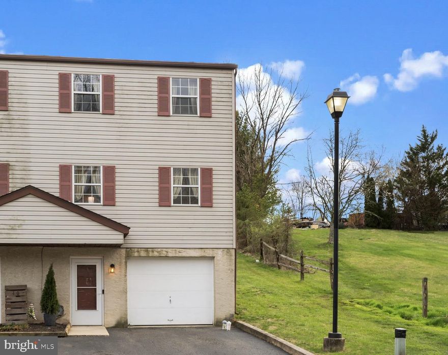 Welcome home! This beautifully maintained 3-bedroom, 1.5-bath end-unit townhome is nestled in the heart of the charming Schwenksville community. Enjoy the convenience of your own 2-car driveway and attached 1-car garage, providing easy access directly into the home. The entry-level offers a spacious storage area and laundry room—perfect for organization and functionality. Head upstairs to the main living level, where you'll find a bright and open floor plan ideal for both everyday living and entertaining. The open-concept kitchen and dining area feature ample cabinet and counter space, creating the perfect setting for gatherings. Sliding glass doors off the dining room lead to your private patio, offering a peaceful outdoor escape. The living room, just off the dining area, provides a versatile space for arranging your furniture just the way you like. A convenient powder room and additional closets complete this level. Upstairs, you'll find three generously sized bedrooms. The primary suite is filled with natural light and features double closets and a private vanity area with direct access to the full bathroom—also accessible from the hallway for added convenience. Two additional bedrooms, both with ceiling fans, offer flexibility for guests, a home office, or hobbies. The community boasts open green spaces, perfect for leisurely walks and outdoor fun. Ideally located near local attractions like the Perkiomen Trail and Spring Mountain Ski Area, this townhome combines comfort, convenience, and charm. You’ll be proud to call this place home!