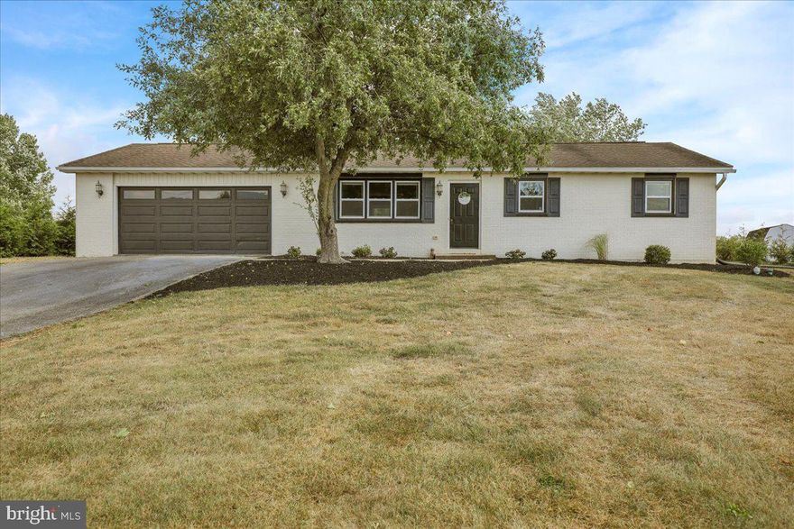 Great rural location for this 3-bedroom ranch home with a view of farmland in the front and backing up to a preserved farm and baseball field. This home features an open layout with updated white shaker cabinetry, granite countertops, shiplap backsplash, new laminate flooring, and  an oversized two-car garage.  Walk out the back sliding door to a large concrete patio and nice level backyard. Brand new hot water heater still in the box conveys with property.  Current water heater is still working but very old.