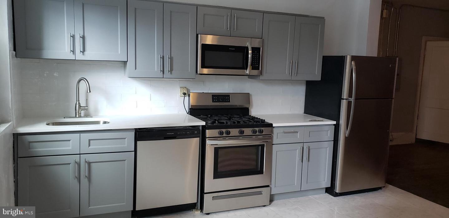 Discover urban living at its finest in this exceptional Center City bi-level apartment. This third-story walk-up offers 4 bedrooms and 2 full bathrooms. Upon entry, ascend to a spacious landing leading to a vast living room with an open floor plan, seamlessly connected to a beautiful kitchen with an eat-in area. The kitchen boasts elegant gray shaker-style cabinetry and stainless steel appliances, including a gas stove, built-in microwave, and dishwasher. Off the living room is a full bathroom with a tub and two well-sized bedrooms. The top floor features another full bathroom with a shower enclosure, a washer and dryer, and two large dormer-style bedrooms. Hardwood floors enhance the charm of the living room and bedrooms. With a Walk Score of 99, Transit Score of 100, and Bike Score of 94, this location is ideal for walkers, riders, and bikers. Situated at 1304 Walnut Street, it’s just a 1-minute walk to the PATCO station and the Broad Street Line, with numerous restaurants, bars, coffee shops, and boutiques nearby. Tenant pays $125/month for water. All square footage numbers are approximate and should be verified by the tenant.