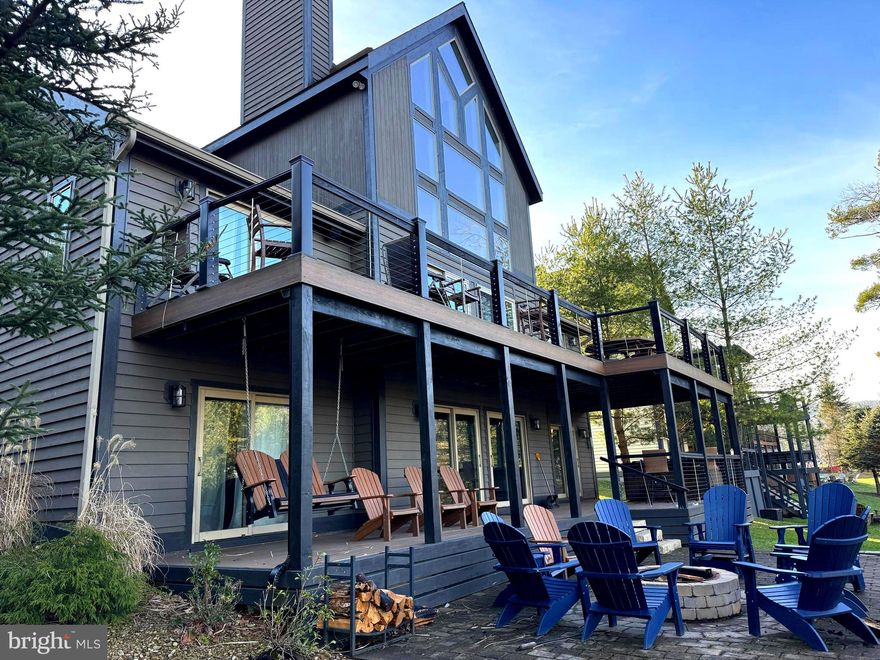 If you're in the market for location, convenience, and rental income,  this inviting 6 Bedroom 4.5 bath Lakefront home is calling for you!  Located in the heart of the action on Deep Creek Lake, the 3 level chateau has been updated and upgraded  both inside and out.   Restaurants, the movie theatre, shopping and Deep Creek Lake State Park are all within walking distance.  

Offering an open layout with abundant glass, there is plenty of natural lighting throughout the floor plan.  Two primary suites with cathedral ceilings and private baths along with 4 bedrooms offering direct bath access allows comfortable sleeping for 12 plus.    The large great room with fireplace and cathedral ceiling  features a beautiful wall of windows overlooking the lake.  The adjoining kitchen and dining areas provide additional space for gatherings and meals.   On the lower level, a family/game room with fireplace includes a second refrigerator and direct lower deck access.  

The newer two level decking system offers unobstructed views and direct hot tub and fire pit access.  Great lake views are available from both levels providing beautiful sunrises and evening shade.  

For those looking for rental income, this property known as Stone Crest knocks it out of the park, averaging over $105,000 in annual gross rental income over the past 3 years.