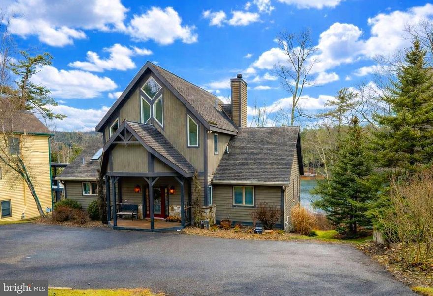 If you're in the market for location, convenience, and rental income,  this inviting 6 Bedroom 4.5 bath Lakefront home is calling for you!  Located in the heart of the action on Deep Creek Lake, the 3 level chateau has been updated and upgraded  both inside and out.   Restaurants, the movie theatre, shopping and Deep Creek Lake State Park are all within walking distance.  

Offering an open layout with abundant glass, there is plenty of natural lighting throughout the floor plan.  Two primary suites with cathedral ceilings and private baths along with 4 bedrooms offering direct bath access allows comfortable sleeping for 12 plus.    The large great room with fireplace and cathedral ceiling  features a beautiful wall of windows overlooking the lake.  The adjoining kitchen and dining areas provide additional space for gatherings and meals.   On the lower level, a family/game room with fireplace includes a second refrigerator and direct lower deck access.  

The newer two level decking system offers unobstructed views and direct hot tub and fire pit access.  Great lake views are available from both levels providing beautiful sunrises and evening shade.  

For those looking for rental income, this property known as Stone Crest knocks it out of the park, averaging over $105,000 in annual gross rental income over the past 3 years.