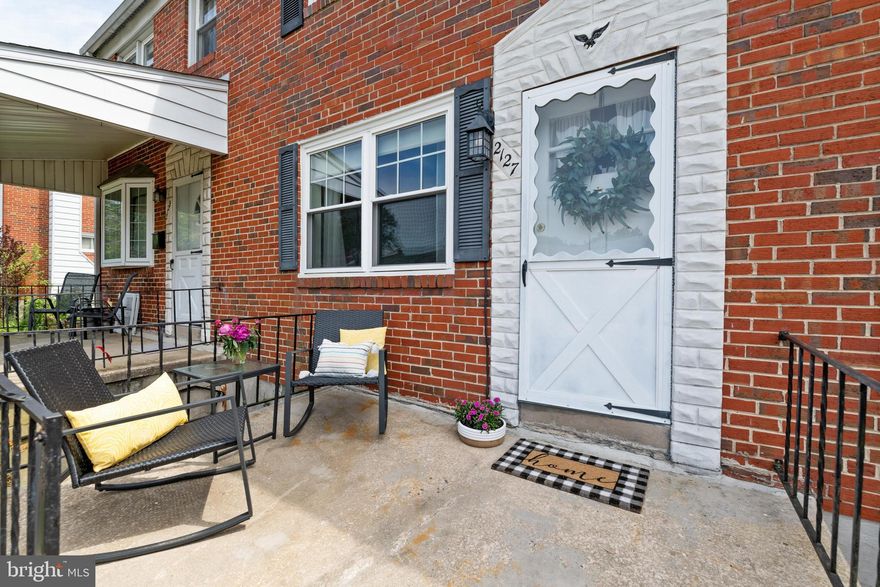 Perfect on Pitney! This 3 bedroom 1.5 bathroom brick front home is waiting for you! Head inside from the charming front porch and into the large light filled living room with hardwood floors that run through to the dining room. The separate dining room features chair molding, a ceiling fan, and plenty of room for dining with friends or family. Head into the kitchen, right off of the dining room, and out onto an entertainer's ideal outdoor space! Set up the back patio with a table and chairs for dining al fresco or relaxing on cool summer evenings. The long fenced space includes a convenient private parking pad. Upstairs are three spacious bedrooms, all with hardwoods and nice closet space, along with a full bathroom. The basement offers a versatile spacious additional living space with vinyl flooring and a fireplace! The unfinished second half of the basement offers ample storage space, laundry, and a brand new door that leads to the backyard. This home is a wonderful opportunity to live in Parkville, convenient to commuter routes, Putty Hill park, and the many shops off of Perring Parkway!