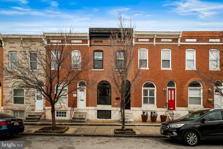 Spacious renovation nestled on a wide, tree lined street in a prime location, just 2 blocks from the beautiful green spaces of Patterson Park, close to dining, shopping, and nightlife in Canton and the Highlandtown Arts District, and convenient to I-95 for commuters. This classic brick front home has been impeccably maintained and has 2+ years remaining on the CHAP TAX CREDIT which saves thousands. This light filled, wide row home offers the perfect mix & warmth of original charm with exposed brick walls and wood floors combined with modern amenities and updates that cater to today's lifestyle. The open floor plan of the main level includes a large living room, dining room, and a beautiful, well designed kitchen with stainless steel appliances, large center island, and upgraded countertops and appliances. The kitchen leads to a private, easy to access rear PARKING PAD! You’ll love the smart layout of the upper level that is great for sharing with a roommate or houseguests. The large primary bedroom suite easily accommodates a king sized bed & offers a private en suite bathroom and great closet space. There is another large bedroom and 2nd full bathroom on this floor along with easy access from the 2nd floor to the multi-tiered decks. The rooftop deck is large and lovely and expands your living space outdoors with city skyline and green park views. The finished lower level includes a large third bedroom, a half bathroom, a separate office/den, laundry, utilities, and storage. This picture perfect home offers a great value with almost 2,000 square feet of finished living space, the ease & convenience of a private PARKING PAD, a location that is close to amenities and commuter routes, and TAX CREDIT savings.