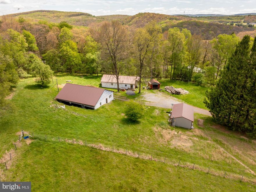 6+ acre homestead with a 4BR, 2BA home currently under construction. Sellers plans have changed and they will not be finishing the house. The structure is under roof, mostly framed-in with building materials on site that will convey with the sale. A new well has been drilled and septic permit is approved for 4BRs. Located just outside of town limits, this parcel has impressive mountain views and accessible pasture land (mostly fenced) with plenty of sunshine and open space. There are multiple outbuildings/garages and a 1985 mobile home (with addition) in place that could possibly be used until the new home is completed. Per GC zoning, the new construction must be completed with new permits prior to occupancy. Unlimited potential at an affordable price!