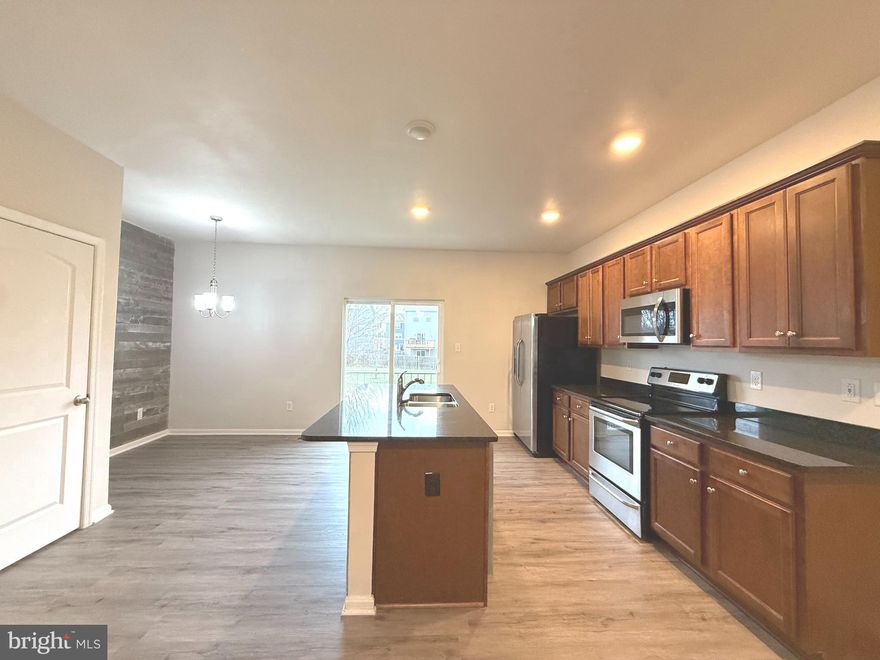 Welcome home to this well-maintained and recently updated 3-bedroom, 2.5-bath townhome in the desirable Berkeley Ridge community of Martinsburg. The first-floor bonus room with a half bath provides flexible use as a home office, guest space, or recreation area—ideal for today’s work-from-home needs.

The open-concept main level features new flooring throughout, a bright living area, and a modern kitchen with stainless steel appliances, a breakfast bar, ample cabinet space, and a new dishwasher. Upstairs, the primary suite offers a walk-in closet and private bath, while two additional bedrooms share a full hall bath.

The home includes new washer and dryer. A finished lower level with walk-out access leading directly to the community playground, offering convenient outdoor access with minimum yard maintenance. An attached one-car garage and driveway parking provide added convenience.

Ideally located near I-81, shopping, dining, and medical facilities, and schools, this property offers an easy commute and access to everyday essentials. Available for immediate occupancy.