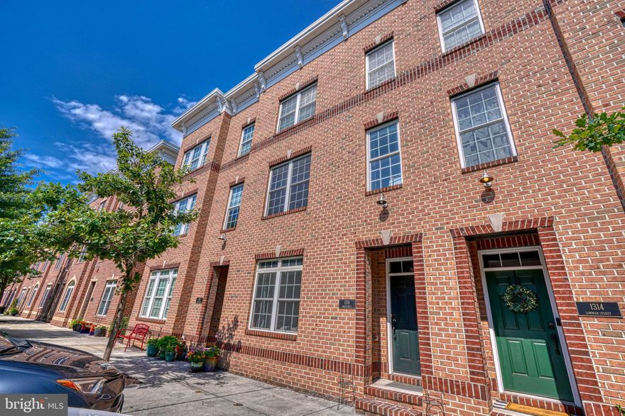 RARE opportunity to rent this large 3-bedroom, 3-full bath garage home in Locust Point. This house has it all. Never worry about parking again, with a 2-car garage and 2 additional parking spots. There are 2 decks. One is just outside the dining room and the other stretches across the roof! At 1316 Lowman you don't have any neighbors to the rear, so your view is only the city line and the harbor! There are hardwood floors on the main level with a contemporary open floor plan and a formal dining room perfect for entertaining. The kitchen is a chef's dream with maple cabinets, granite counters, stainless steel appliances, and breakfast bar. The master suite is quite large with a walk-in closet and luxury bath. On the same level is another large bedroom and another full bath. At the entry level there is a 3rd bedroom and another full bathroom. Access to the 2-car garage is on the entry level as well. Walk to Under Armor and Latrobe Park. Convenient to 95 and downtown!