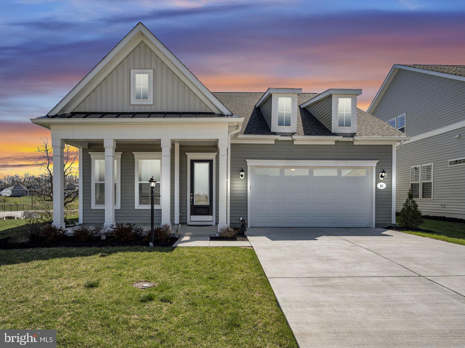 **Back on the market due to no fault of the seller and now at a new price!** Situated on one of Amblebrook’s most sought-after lots, this nearly new home is loaded with over $100,000 in upgrades, saving you the time, cost, and hassle of doing them yourself! With no homes behind, across, or on one side, this property offers rare privacy, peaceful tree-lined views, and incredible natural light. Morning sun gently warms the home, while the east-facing sunroom and patio stay cool in the afternoon, making the outdoor spaces enjoyable all day long.
Inside, you’ll find a bright, open layout with tall, 10-foot ceilings and a huge living area which is perfect for a piano, art studio, or any hobby space you imagine. A gorgeous 3-season sunroom, wrapped in windows and anchored by a stunning stone fireplace, opens onto a lit patio ideal for morning coffee or evenings under the stars. The kitchen and living spaces flow seamlessly, while the flex room easily doubles as a guest bedroom or office. The primary suite was thoughtfully bumped out for extra room and features electric blinds and a custom walk-in closet with built-in organizers. Convenience and style continue with a built-in drop zone by the garage entry, an upgraded laundry room with added cabinetry and a utility sink, and an epoxied garage floor. The front walkway has been upgraded with stamped concrete, and a water purification system is already installed. With no pets ever in the home, it’s an ideal choice for allergy-sensitive buyers. Originally designed as a forever home, a change in remote work means this move in-ready home can now be yours! Located just a short walk from Amblebrook’s incredible amenities—24,000 sq. ft. clubhouse, fitness and wellness centers, pools, trails, dog parks, and a vibrant social calendar, this home combines a premium lot, high-end upgrades, and a resort-style lifestyle you’ll love.