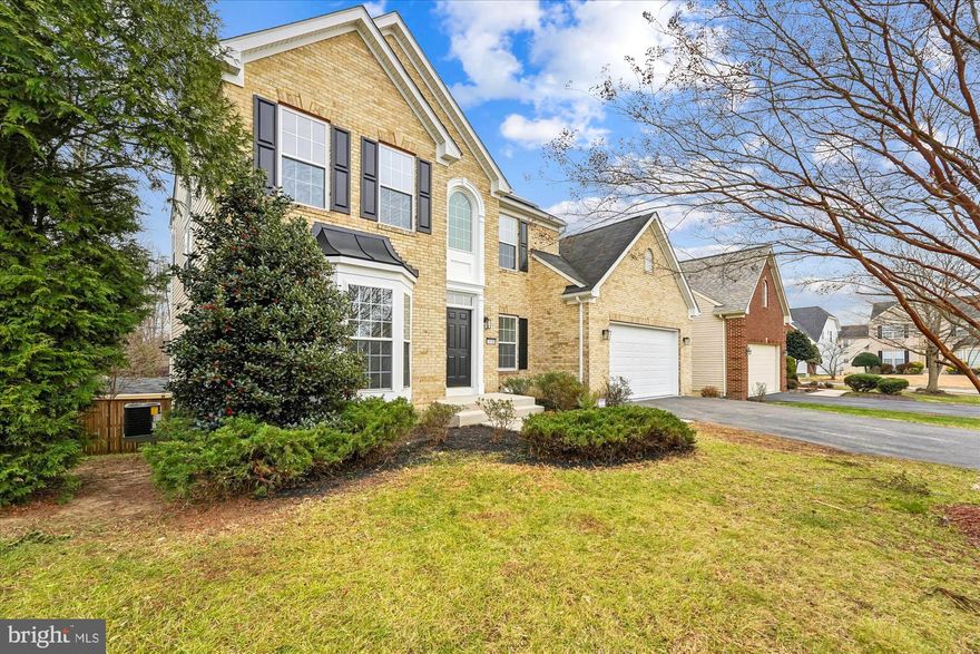 This is the home you've been waiting for, nestled in a peaceful cul-de-sac in the prestigious Hampton community.  This stunning brick-front colonial blends timeless charm with modern comfort, offering three expansive levels designed for effortless living, entertaining, and relaxing. With 9-foot ceilings, abundant natural light, and inviting architectural details, this home delivers the warmth and sophistication buyers crave. Step through the grand two-story foyer, where sunlight pours in and sets the tone for the elegance that awaits.  At the heart of the home, the gourmet kitchen impresses with generous cabinetry and a cozy breakfast nook perfect for casual mornings or hosting unforgettable gatherings. The kitchen opens to a dramatic family room with a fireplace, creating a warm, airy space ideal for making memories with loved ones.  Need room to work, unwind, or pursue hobbies? You’ll find it here. A dedicated library/office offers quiet focus, while the sun-drenched sunroom, wrapped in windows, invites relaxation all year long.  Upstairs, the luxurious owner’s suite is your private sanctuary, featuring two walk-in closets, a spacious sitting area, and a spa-like en-suite bath with a jacuzzi tub. Three additional generous bedrooms and a beautifully updated hall bath provide comfort and convenience for family or guests.  The possibilities continue with a fully finished walk-out basement with a full bathroom.   A two-car garage and private driveway add ease to everyday living.  Dual Zones with Solar Panels for savings all year round. Perfectly situated near Routes 301 and 5, this home offers quick access to shopping, dining, and an easy commute to Washington, D.C.  Homes like this don’t come along often. Experience the very best of Hampton living. Schedule your private tour today and make this dream home yours!