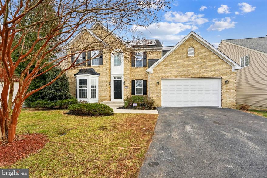 This is the home you've been waiting for, nestled in a peaceful cul-de-sac in the prestigious Hampton community.  This stunning brick-front colonial blends timeless charm with modern comfort, offering three expansive levels designed for effortless living, entertaining, and relaxing. With 9-foot ceilings, abundant natural light, and inviting architectural details, this home delivers the warmth and sophistication buyers crave. Step through the grand two-story foyer, where sunlight pours in and sets the tone for the elegance that awaits.  At the heart of the home, the gourmet kitchen impresses with generous cabinetry and a cozy breakfast nook perfect for casual mornings or hosting unforgettable gatherings. The kitchen opens to a dramatic family room with a fireplace, creating a warm, airy space ideal for making memories with loved ones.  Need room to work, unwind, or pursue hobbies? You’ll find it here. A dedicated library/office offers quiet focus, while the sun-drenched sunroom, wrapped in windows, invites relaxation all year long.  Upstairs, the luxurious owner’s suite is your private sanctuary, featuring two walk-in closets, a spacious sitting area, and a spa-like en-suite bath with a jacuzzi tub. Three additional generous bedrooms and a beautifully updated hall bath provide comfort and convenience for family or guests.  The possibilities continue with a fully finished walk-out basement with a full bathroom.   A two-car garage and private driveway add ease to everyday living.  Dual Zones with Solar Panels for Year-Round Savings. Perfectly situated near Routes 301 and 5, this home offers quick access to shopping, dining, and an easy commute to Washington, D.C.  Homes like this don’t come along often. Experience the very best of Hampton living. Schedule your private tour today and make this dream home yours!