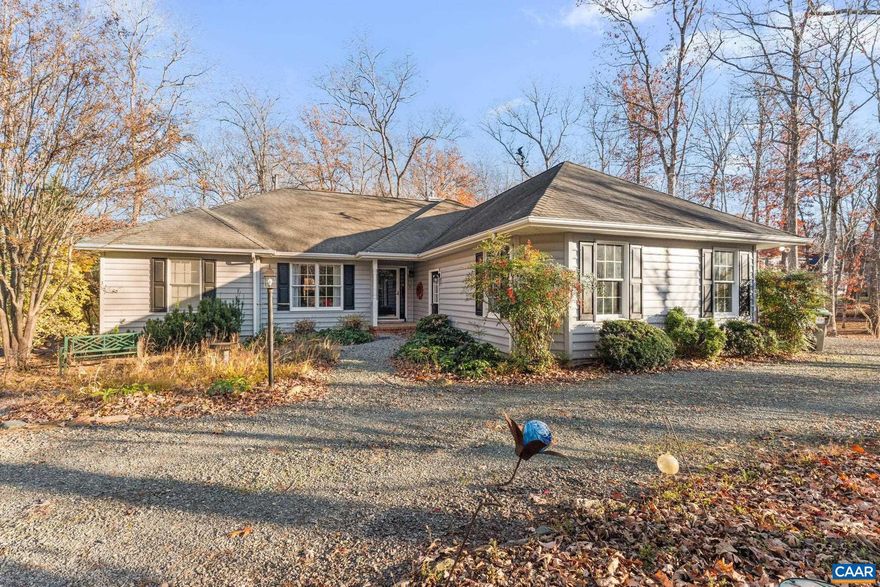 Discover comfort and convenience in this light-filled 3 bedroom, 2 bath home nestled on a large, beautifully landscaped corner lot. Split bedroom design offers privacy, featuring a spacious owner?s suite with plenty of natural light. The eat-in kitchen boasts warm maple cabinets, a breakfast nook, and flows effortlessly into the bright main living area, highlighted by a cozy gas fireplace. Step outside to a screened-in porch, perfect for relaxing or entertaining while enjoying views of the lush wooded surroundings. A side-load garage provides ample storage, while the circular driveway adds convenience and curb appeal. With extensive landscaping and a thoughtfully designed layout, this one-level gem combines style, comfort, and easy living?all within the amenities of the Lake Monticello community.,Formica Counter,Maple Cabinets,Fireplace in Living Room