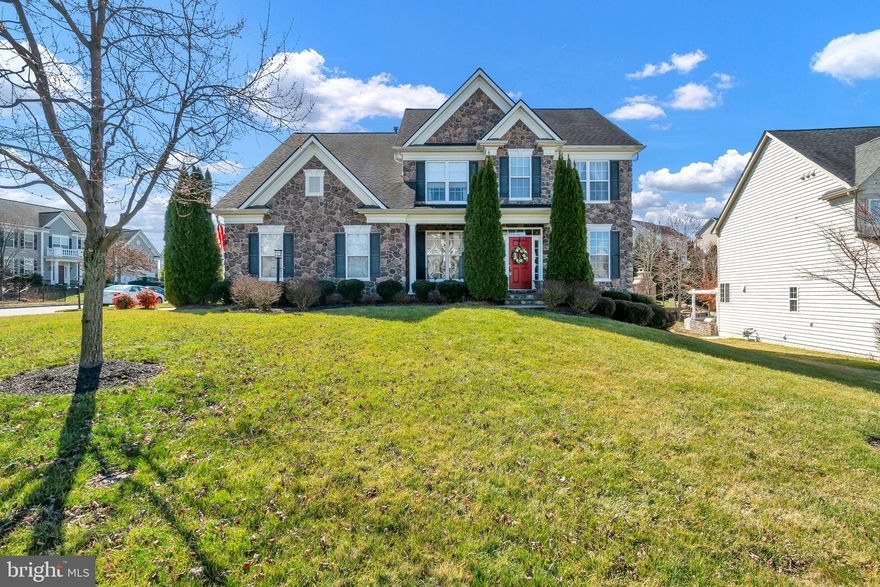 Beautiful stone front single family home in Northern Stafford with a model like feel. Perfect in every detail - vibrant yet elegant. Stunning gourmet kitchen with stainless steel appliance, double oven , great pantry and beautiful island leads to a deck that has stairs to backyard paradise with built-in grill and entertainment center for gatherings with fridge and abundance of space. 3 fridges total. The ground sprinkler system will keep your grass looking like carpet. Inside the family room has been decorated with a coffered ceiling and offers a gas fireplace. The dining room connects to the kitchen with a butler's pantry.  Large dining room, lovely sitting room that can easily be used as an office and large main level suite make this home perfect for main level living should you need one.
Upstairs there are 4 bedrooms with a huge primary suite - there are tray ceilings, a sitting room connected with the primary bedroom by 3 sided gas fireplace, large two walk in closets and beautiful bright bathroom with separate shower and jetted soaking tub.
Other bedrooms have a Jack and Jill type of bathroom. The last bedroom is the suite with its own bath.
Hardwood floors through the main level up the stairs and through the hallway.
The basement is a walk up with plenty of light. The basement is unfinished with plumbing rough in - great canvas to make your own. It is truly an amazingly kept like brand new home.