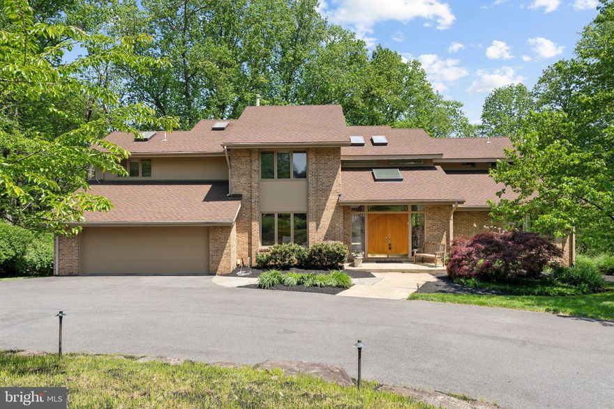 An Architectural Statement in Glen Hills

Tucked away on a quiet cul-de-sac in the coveted Glen Hills community, 6 Monterra Court stands as a testament to elegance. Masterfully designed by Greenspan Builders, this exceptional residence is gracefully sited on a lush three-quarter-acre lot, offering complete privacy and breathtaking views of the 8th hole at Lakewood Country Club.

Beyond the impressive double-door entry, a soaring two-story foyer unfolds, drenched in natural light and framed by dramatic vaulted ceilings. Every detail of this home speaks to refined craftsmanship, from the bespoke natural stone fireplace soaring two stories high, to the custom cabinetry that subtly elevates the expansive family room.

The heart of the home is the stunning island kitchen, an entertainer’s dream featuring a Sub-Zero refrigerator, professional-grade five-burner cooktop, double wall ovens, and a generous breakfast area that opens seamlessly to an oversized deck. Here, mornings begin with coffee overlooking manicured greens, and evenings end with golden sunsets sinking behind the treetops.

For those who work from home, the dedicated office offers an inspiring setting with rich built-in cabinetry and calming views of the surrounding landscape. The main level also boasts two powder rooms, a full-sized laundry room, and an oversized two-car garage for effortless convenience.

Upstairs, four beautifully proportioned bedrooms and three full baths await, including a magnificent primary suite with a private balcony — the perfect place to retreat with a book or glass of wine under the stars.

The lower level redefines the concept of a basement, offering full-sized windows, wide-open living spaces, a full bath, and access to a sprawling stone patio complete with a private hot tub — an indulgent oasis designed for relaxation and entertaining.

Throughout the home, modern comforts abound, including a two-zone heating and cooling system, two water heaters for endless hot showers, and abundant storage space for all of life’s necessities.

In every way, 6 Monterra Court offers a lifestyle of casual sophistication — a home where architecture, nature, and everyday living come together in perfect harmony. Rarely does an offering so effortlessly blend serenity, luxury, and location.