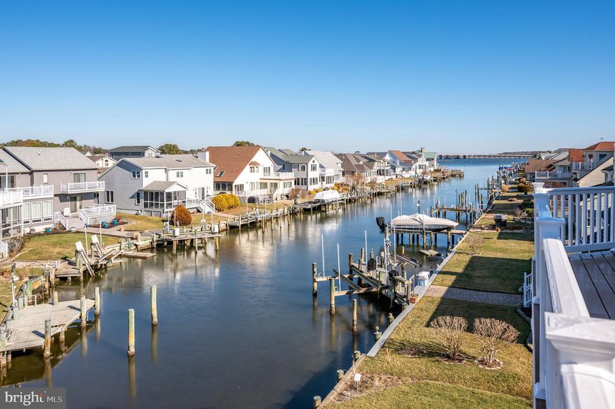 This stunning 4BR/3BA/2HBA  waterfront home in Ocean Pines is located on the canal with direct bay access.  This home is in the prestigious Terns Landing section of Ocean Pines and boasts 3,900 sq.ft. with an abundance of natural light throughout.  You will fall in love with the open floor plan and there is plenty of space for everyone. The chef in your family is going to love the upgraded kitchen with quartz countertops, backsplash, soft closing cabinets with plenty of storage space, a center island, oversized pantry, beverage center and upgraded lighting.  The kitchen flows nicely to the dining area where you're sure to enjoy many meals with family and friends. The dining area flows to a family room with gas fireplace.  The master bedroom is oversized and has a luxurious bathroom.  There is a second master bedroom with full bath and 2 additional bedrooms with a Jack and Jill bath. The home was built with room for a future elevator. If you work from home you will love the home office. There is a large playroom or second family room on the first level as well. There are 2 oversized garages that will fit large SUVs.  One of the garages also opens on the water side for easy access in and out for your water toys.  There are multiple decks on the front and back of the home with breathtaking bay views, and there is plenty of room on the decks to enjoy a crab feast or outdoor barbeque.  On the first level there is also an outside fireplace for those fall nights.  The property is bulkheaded and has water hookup at the dock. Put in a pier and lift for your boat or jetski or tie up your pontoon boat. This property has the added bonus of being alongside a lovely quiet park providing an extended outdoor living area which is maintained by the association. Enjoy everything the amenities rich community of Ocean Pines has to offer, including: 5 swimming pools (1 pool is enclosed and heated and open year-round), Yacht Club and restaurant, marina, boat ramp, golf course with club house, Community Center, multiple playgrounds and parks, tennis basketball and pickleball courts, skateboard park, walking/biking trails, community police and fire departments and beach club on the ocean with ocean front pool and parking, and more!  Come take a look today before it's SOLD!!