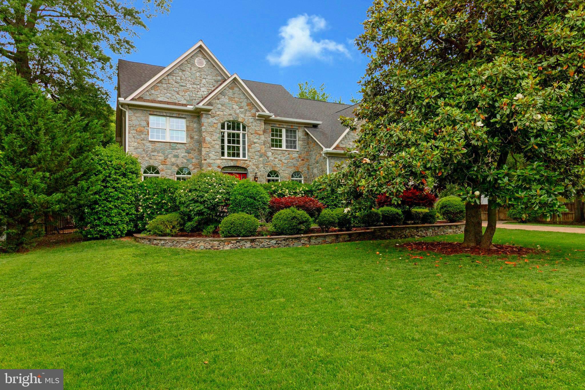 Nestled behind a private gated entrance on over three-quarters of an acre, this remarkable estate offers unmatched privacy, luxury, and space to live, entertain, and relax. With nearly 6,000 square feet of elegant living space, this one-of-a-kind home in the coveted Fort Hunt community is the perfect blend of comfort and sophistication. Step through the front door and be greeted by soaring vaulted ceilings and a grand staircase that sets the tone for the rest of the home. The main level is designed for both formal and casual living with a spacious living room, elegant dining room, private office, and a gourmet kitchen featuring a large island with new quartz countertops that opens to a dramatic, vaulted-ceiling family room with a cozy gas fireplace.
From the family room, sliding glass doors lead to what may be one of the most impressive backyards in Alexandria. This outdoor oasis includes a large pool, relaxing hot tub, custom putting green, charming gazebo, and a fully-equipped tiki bar with an outdoor kitchen—ideal for hosting unforgettable gatherings. The yard is beautifully landscaped and wired for sound and ambient lighting, with ample room to add a pool house or auxiliary dwelling unit if desired. Upstairs, you'll find four spacious bedrooms, including a luxurious primary suite with a sitting area, double closets, gas fireplace, and a spa-like bathroom. The finished lower level offers even more room to spread out and enjoy, with a third gas fireplace, a recreation area perfect for a pool or ping pong table, a home theater, an additional bedroom, and a versatile workout or bonus room. An oversized two-car garage completes the home and includes an electric car charging setup. Located just south of Old Town Alexandria and minutes from Highway 495 and Reagan National Airport, this property is a commuter’s dream. The Fort Hunt community offers outstanding youth sports programs and access to the newly-renovated Mount Vernon Community Center, soon to feature two ice rinks, a swimming pool, and fitness facilities. Enjoy the charm of neighborhood living with seasonal farmers markets, the Sherwood Hall Library nearby, and so much more.