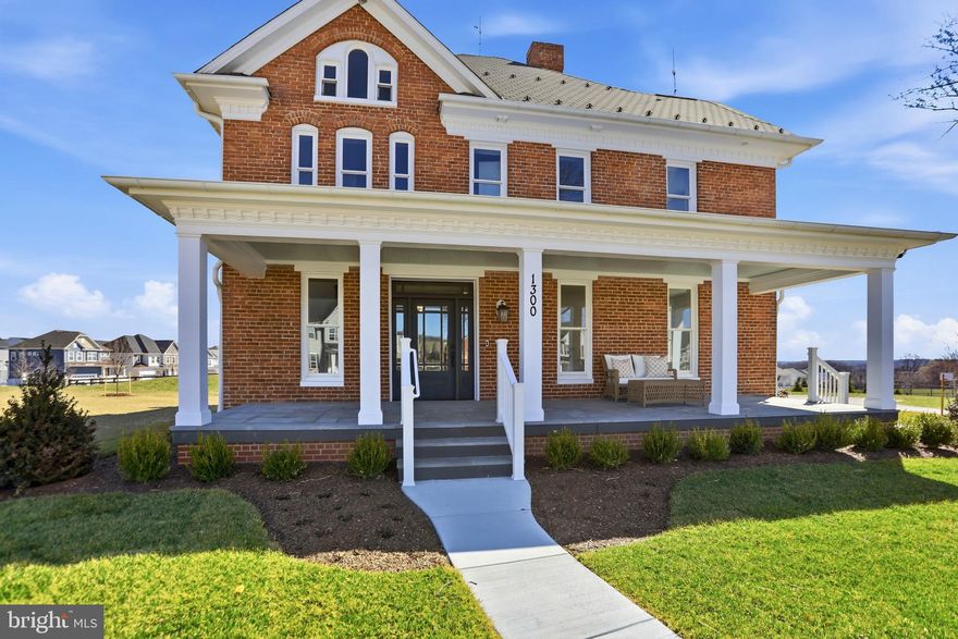 The original Brunswick Crossing manor house—completely reimagined in 2025–2026 by one of Frederick County’s most respected builders—is now offered for sale. Known as **The Enfield House**, this iconic all-brick Colonial Revival residence was originally built in 1900 and stands today as a rare architectural landmark overlooking the Brunswick Crossing community.

Set prominently on its elevated homesite, the home offers more than 3,400 finished square feet across the upper levels and has undergone a comprehensive down-to-the-studs renovation. Every major system and finish has been thoughtfully replaced or upgraded, preserving the home’s historic character while delivering the comfort and efficiency of modern construction. The only elements retained from the original structure are the timeless four-sided brick exterior and the beautifully preserved original hardwood floors—an intentional blend of historic craftsmanship and new-home quality.

The home’s gracious slate front porch captures the cool breezes that sweep through the Harpers Ferry Gap, creating the perfect setting for quiet mornings or relaxed evenings overlooking the surrounding valley. At the rear, an oversized elevated covered porch offers a dramatic vantage point above Brunswick Crossing, where scenic vistas and mountain views stretch into the distance.

Inside, classic Colonial Revival architecture meets fresh, modern design. Generous room proportions, tall ceilings, and abundant natural light create an inviting and sophisticated interior environment. The renovation has carefully respected the home’s historic scale while delivering a flowing layout suited to today’s lifestyle—ideal for both everyday living and elegant entertaining.

Residents of Brunswick Crossing enjoy access to an exceptional array of community amenities designed to support an active and connected lifestyle. The community features a resort-style swimming pool, state-of-the-art fitness center, and a beautifully appointed clubhouse that hosts neighborhood events and gatherings throughout the year. Miles of scenic walking and biking trails wind through parks, open green spaces, and playgrounds, while sports fields, dog parks, and community gardens create opportunities for recreation and outdoor enjoyment. The neighborhood also includes a vibrant marketplace with local shops and dining, along with convenient access to the MARC train, historic downtown Brunswick, the C&O Canal towpath, and endless outdoor recreation along the Potomac River.

Homes with this level of architectural significance rarely come to market—especially ones that have been fully restored with such care and intention. The Enfield House offers a truly unique opportunity to own a piece of Brunswick history while enjoying the benefits of a completely modernized home.

A landmark residence. A meticulous restoration. And one of the most distinctive homes in all of Brunswick Crossing.