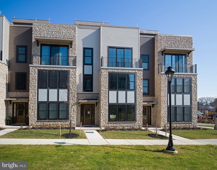 Step into the epitome of contemporary living with this move-in ready townhome, just steps away from a vibrant array of new shops, restaurants, and boutique exercise studios. Experience the ultimate in convenience and luxury within The Towns at Newtown Walk, a sought-after community where every amenity is within easy reach.

This meticulously crafted end townhome promises the perfect blend of style and low-maintenance living. Situated in a prime location within the thriving community, you'll find yourself just a leisurely walk away from Whole Foods, charming local cafes, and tempting eateries, making every day a delightful exploration of your neighborhood.

Immerse yourself in the contemporary design of this new construction gem, showcasing a distinctive floor plan that has captivated discerning homeowners. From the 4-stop ELEVATOR in the welcoming foyer to the well-appointed guest bedroom or office space on the first level, this home is thoughtfully designed for modern living. The convenience of a 2-car garage and a spacious driveway ensures hassle-free parking for you and your guests.

The main living level beckons with 10-foot ceilings, an open concept design, and a kitchen that steals the spotlight. Bathed in natural light, the kitchen boasts 42" soft-close cabinets, quartz countertops, a sprawling island, and top-notch stainless steel appliances. The chic dining area and spacious living area with a gas fireplace make entertaining effortless.

Escape to the tranquil primary bedroom, complete with a generous walk-in closet and an ensuite bathroom featuring a walk-in shower and stylish double vanity. A second guest suite bedroom, laundry facilities, and a linen closet round out the thoughtfully designed upper level.

However, the true pièce de résistance awaits on the rooftop terrace – a sun-drenched haven offering ample outdoor space. Picture yourself sipping morning coffee with the sunrise or enjoying al fresco dinners. This space even invites you to try your hand at planter gardening or create a cozy fireplace or BBQ area.

Don't miss your chance to be a part of The Towns at Newtown Walk, your gateway to the thriving Ellis Preserve community. With easy access to major roadways, the airport, train station, and Routes 252 and 3, your daily commute becomes a breeze.

Seize this opportunity to transform this exceptional modern townhome into your new sanctuary!