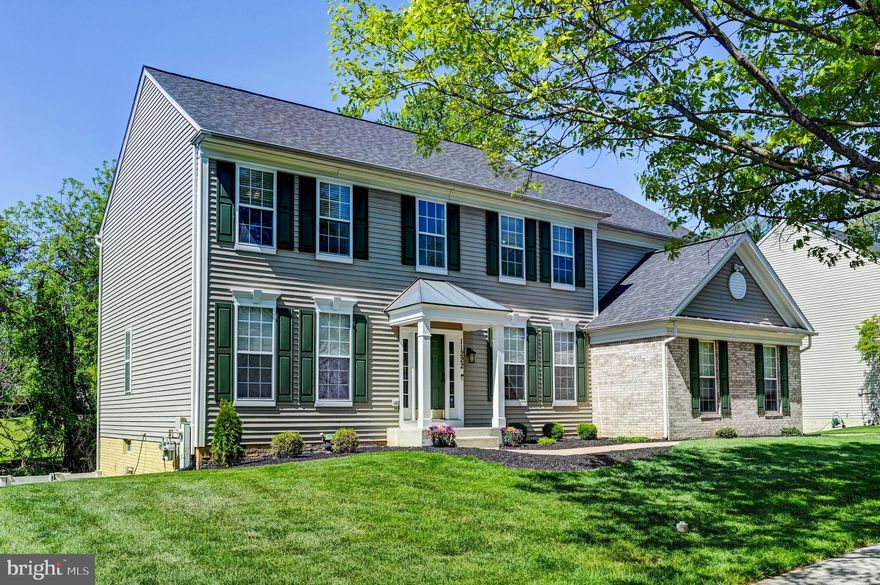 This exceptional five-bedroom, three-and-a-half-bath residence—complete with a side-loading two-car garage—is ideally positioned just minutes from the rolling hills and pastoral beauty of Worthington Valley. Meticulously updated and masterfully designed, the home offers over 4,000 sq. ft. of refined living space that blends timeless elegance with modern comfort.
The main level welcomes you with a grand two-story foyer accented by rich wainscoting. Formal living and dining rooms boast decorative millwork, deep crown molding, and abundant natural light. A well-appointed butler’s pantry with glass-front cabinetry leads to the gourmet eat-in kitchen, featuring 42-inch white cabinetry, granite countertops, a center island, upgraded stainless steel appliances, a planning desk, generous table space, a pantry, and sliders opening to the expansive Trex deck with metal pavilion and additional seating area—perfect for outdoor dining and entertaining.
The impressive two-story family room offers stacked windows dressed in white wood blinds, a gas fireplace with marble surround and custom millwork, recessed lighting, and a dramatic second-floor overlook. A private library completes this level with built-in desk, upgraded carpet, decorative moldings, and recessed lighting. The elegant powder room features an upgraded vanity with quartz top, designer tile, and modern fixtures. A mudroom and laundry room with custom built-ins and front-loading washer and dryer provide everyday convenience.
The upper level showcases a serene primary suite with floor-to-ceiling windows enhanced by plantation shutters. The spa-inspired primary bathroom includes an oversized walk-in shower, freestanding soaking tub, dual-bowl vanity with quartz countertop and makeup area, upgraded "marble" tile floor and shower surround, a large linen closet, and an expansive walk-in clothes closet. Three additional generously sized bedrooms, an updated hall bathroom, and a linen closet complete this level.
The walkout lower level is ideal for relaxation and recreation, offering a spacious rec room with wet bar, a large bedroom or exercise room with walk-in closet, a full bathroom, and a sizable storage area. A French door leads to the concrete patio with designer stamped surround, fenced rear yard with mature trees, and a five-person hot tub, creating a private outdoor retreat.
Recent updates and features include: hardwood flooring throughout most of the main and upper levels; LVT and tile flooring in the lower level; stamped concrete front walkway; updated main and upper-level bathrooms (2021); painted kitchen cabinetry (2021); fresh interior paint (2021); refrigerator (2025); dryer (2025); new A/C (2019); new architectural shingle roof (2019); outdoor speakers and basement surround sound (as-is); custom window treatments; recessed lighting; upgraded plumbing and lighting fixtures; MyQ-enabled garage door opener; programmable Nest thermostat; Nest doorbell camera; and more.
The community features two tot lots with gazebos and an active HOA.  This extraordinary home offers the perfect blend of sophistication, comfort, and convenience—delivering an unparalleled lifestyle moments from the scenic countryside of Worthington Valley, 795, and 695.