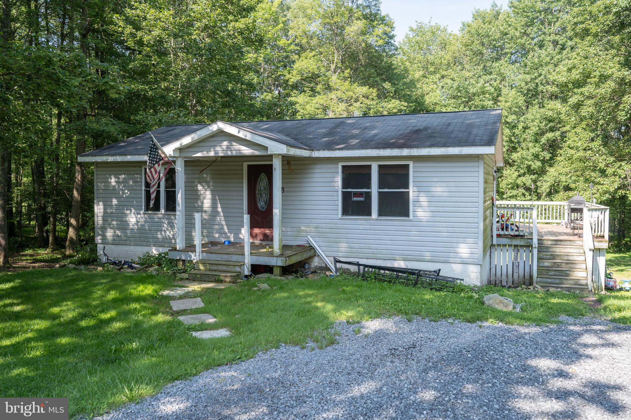 Set between Oakland and Deep Creek, this main-level ranch runs new granite, black stainless, six-burner gas, and dual-ice fridge. Baths are tiled with updated vanities and floors. Plank flooring throughout. Basement is unfinished with storage, laundry, walkout, and room to expand. Heat pump with electric backup and central air. Vinyl siding, newer roof, wraparound deck. Extra wooded lot next door included totaling almost 2 acres! Close to Swallow Falls and Yough access.