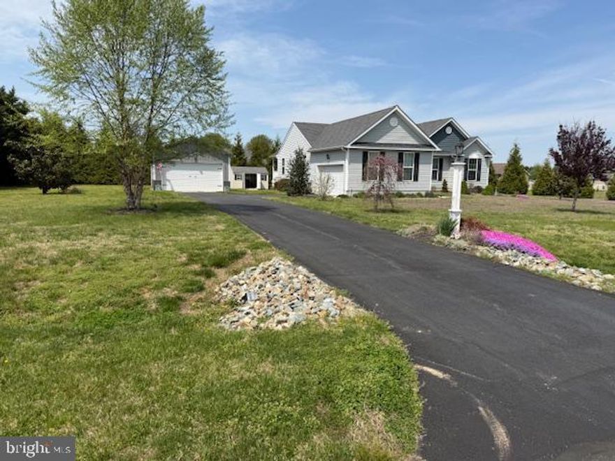 Its hard to find a better location or home condition than you get here.  Exceptional 12 year old home on a .78 acre lot with amazing style.  As soon as you enter, you feel the grandness of the vaulted living room area with gas fireplace and a separate yet cozy dining room.  The open floor plan flows over from the kitchen area complete with ample cabinets and granite countertops.  The breakfast nook area leads to the covered deck.  The primary bedroom is a dream space with large closet and bright spacious bathroom, complete with double sinks, walk in shower and a soaking tub.  The two additional bedrooms are comfortable in size with good closet space.  The second bath is immediately accessbile outside the bedrooms.  And YES, there is a HUGE basement...you pass the laundry room on the way and then down the stairs to a blank canvas of space.  An egress window is present.  The mechanicals are tucked away in the corners to allow for open, usable square footage.  And YES again, an additional detached garage for your extra vehicles, toys, hobbies, storage etc.  Easy 4 min. commute to Rte 1 and short ride to Lewes beaches.