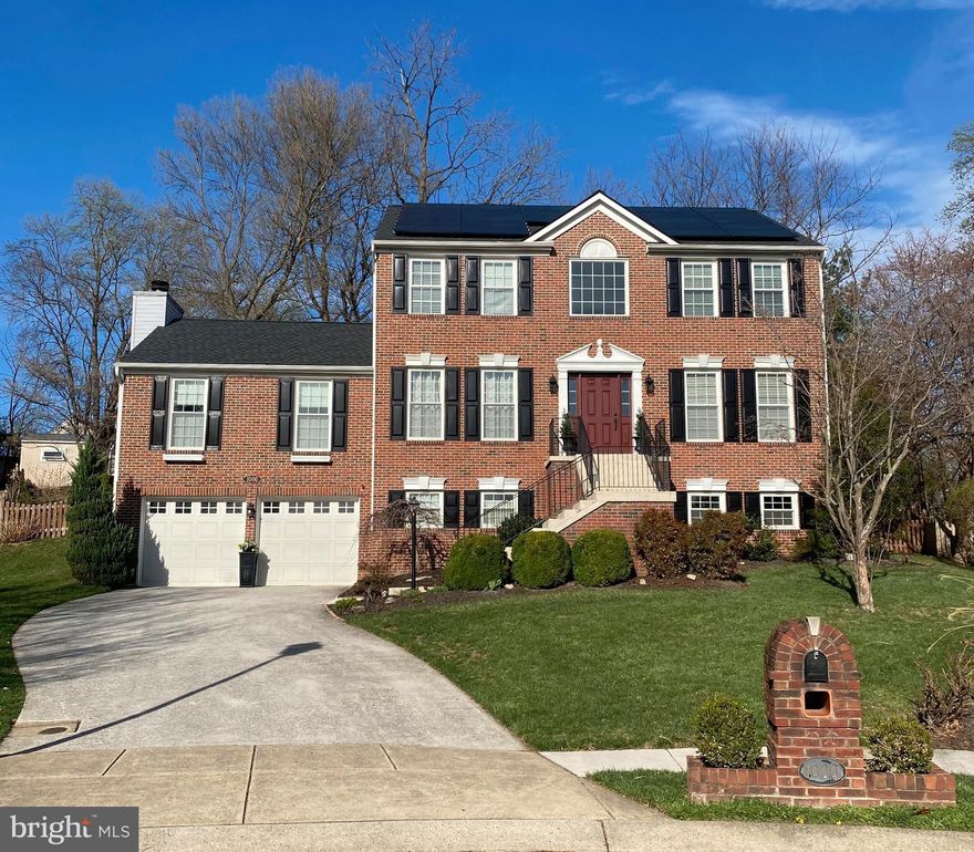 Wonderful home in the high-demand Courts of Four Seasons community at the end of a large cul-de- sac. The conveying solar panels are OWNED (not leased) helping to substantially save on utility costs. Original owners have done a fantastic job of maintaining the home. Walk up the grand front entrance, past the well appointed landscaping and into a welcoming 2-story wainscoted foyer. Hardwood floors throughout the first floor. The large dining room is on the right and also showcases wainscoting. The den/office is to the left, leading to an incredible, expansive family room with high vaulted ceilings showcasing decorative wood beams and a wood-burning fireplace with floor-to-ceiling stone that's the focal point of the room. Gas conversion of the fireplace, if so desired, should be a straight forward matter. If one office isn't enough, the dining room is perfectly situated with enough separation to make a second home office that could easily accommodate more than one person. Walking straight through the foyer, to the back of the house,  you arrive in the eat-in area with the full kitchen to the left. The spacious updated kitchen can accommodate multiple people cooking and socializing with direct access to the aforementioned family room. The double oven range means extra cooking space for entertaining. There's eat-at counter space. Laundry room is behind a door directly off the kitchen. As currently set up, the entire back right area has a large table and seating, Alternately, the area could host a smaller eat-in area with a smaller table and a comfortably sized living room perfect for relaxing and enjoying a good book. There's even a cozy window seat in the bay window. Walking out the back French door, you step onto an expansive, multi-level deck backing to green space and offering outdoor privacy. There's a shed to store all of your outdoor play and equipment needs. The yard is fenced and offers plenty of space for kids and dogs. Back in the house, we head to the upstairs foyer and the grand master bedroom with vaulted ceilings, adding to the open feel of the space. There's a large walk in master closet with a well organized closet system off the hall leading to the updated master bathroom, featuring a double vanity, soaking tub, and glass surround stall shower. There are 3 more bedrooms, 2 of which feature built-in shelving, desks, and storage. The bathroom in the hall provides plenty of vanity-top space as far as shared bathrooms go. Heading down to the basement, we find a very large rec room with a a pool table. There's also a great wet-bar for entertaining. The pool table, billiards supplies, and sectional sofa all convey with the house if you want them.  The basement also features a full bathroom. There's a large storage room housing the water heater and air handler. There's another storage room, currently serving as a perfectly sized home workshop with natural daylight from the front facing window.. There's a hallway leading to the garage for dry entry into the house on wet or snowy days. Full size 2-car garage. LOCATION, LOCATION, LOCATION! This home is 10 minutes to Odenton MARC train station, 20 minutes to Ft. Meade/NSA, 20 minutes to BWI airport and Amtrak station, 5 minutes to the shops/restaurants at Waugh Chapel, and centrally located to Baltimore, DC, and Annapolis.