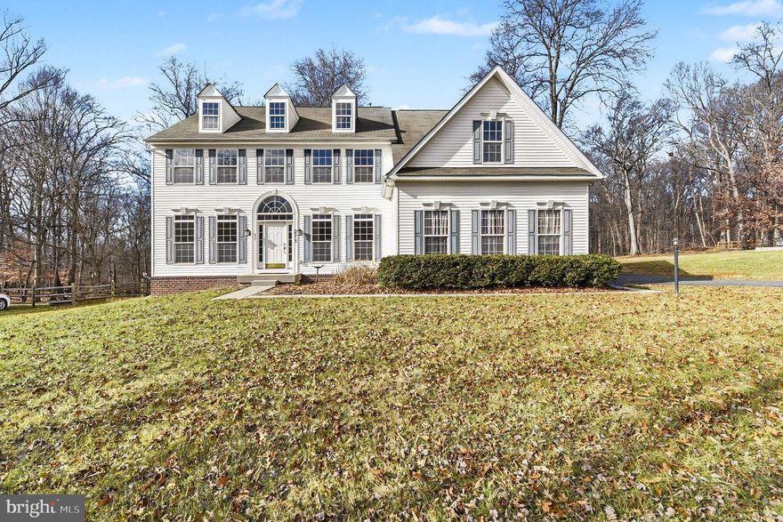 Welcome to Rock Run Estates! This stunning home is beautifully situated on over 1.25 acres, offering space, privacy, and a perfect setting to make it your own. Upon entering, you are immediately greeted by soaring ceilings, abundant natural light, rich hardwood floors, and a striking grand staircase, all complemented by fresh paint throughout most of the home. To the left of the entry, a spacious formal living room provides an elegant gathering space, while the dining room to the right is ideal for hosting memorable meals. Toward the rear of the home, the expansive kitchen is a chef’s dream, featuring an enormous island, ample counter space, stacked wall ovens, a gas range, and a large walk-in pantry. Just off the kitchen, two additional spaces—the bright sunroom and a generous family room with bamboo flooring—offer versatile areas for entertaining, relaxing, or spending time with family, and include a second staircase to the upper level. Making your way to the upper level, elegant overlooks lead to the luxurious primary suite and four additional bedrooms. The primary suite offers space for a sitting area and a large walk-in closet, while the spa-like bathroom is appointed with tile flooring, double vanities, a soaking tub, and a tile walk-in shower. Bedroom two features its own sitting area, walk-in closet, and a Jack-and-Jill bathroom shared with Bedroom three. Bedrooms four and five, along with a third full bathroom, complete this level, providing ample space for family and guests. The partially finished basement provides flexible, inviting space with beautiful laminate flooring throughout most of the finished areas and recessed lighting. It includes a full bath with a tile walk-in shower, a kitchenette, and walk-up stairs to the backyard, ready for your personal vision, along with plenty of storage. Outside, the oversized two-car garage provides additional storage, while the expansive lot showcases gorgeous spring landscaping, perfect for entertaining. A resurfaced deck and hot tub enhance outdoor living and enjoyment. This home is equipped with dual-zone heating and air, supported by a 1,000-gallon owned propane tank, with one HVAC unit less than seven years old and the other under one year. Additional updates include a water heater under six years old, two electrical panels with the generator on a dedicated panel, sump pump less than one year and a septic system last pumped in 2025, ensuring peace of mind for years to come.