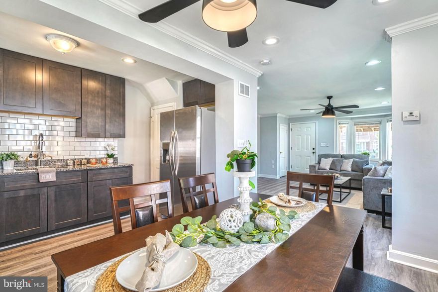 ***  MOVE RIGHT IN *** to this BEAUTIFUL  3 BEDROOM / 2 FULL BATH  *END-of-GROUP* Townhome with a spacious FRONT PORCH (with wheelchair lift onto porch), and 3 BEAUTIFULLY FINISHED LEVELS including a lower level SPACIOUS 21x15 FAMILY ROOM w/ BARN-STYLE SLIDING DOORS, & PARKING FOR 2 VEHICLES!  __MAIN LEVEL__ is OPEN CONCEPT and includes  a GORGEOUS KITCHEN w/  GRANITE, STAINLESS STEEL APPLIANCES, 5-burner GAS STOVE, EXTRA DEEP SINK, LUXURY WATERPROOF VINYL PLANKING throughout,  a DINING RM & LIVING RM w/CROWN MOLDING, RECESSED LIGHTING,  & 2 LARGE BAY WINDOWS, making for a bright open space! __UPPER LEVEL__ includes 3 Bedrooms, Shelved Linen Closet, pull-down stairs into Attic, and a BEAUTIFUL FULL BATH w/TILED TUB SURROUND & TILED FLOORING!  __LOWER LEVEL__  offers a LARGE 21x15 FAMILY RM (which could serve as a 4TH BDRM!), w/RECESSED LIGHTING, BARN-STYLE DOORS,  ATTACHED FULL BATH w/TILED WALK-IN SHOWER, & a dedicated Laundry/Utility Room with WASHER/DRYER,  with an exit to PARKING PADS in rear for 2 VEHICLES!!  LOCATED near shopping, restaurants, & several parks (Merritt Point Park, Chesterwood Park, Stansbury Park with Pond, Fishing Pier, and Walking Trail), & with easy access to 695 and 95, this home is a GREAT OPPORTUNITY!! *** DON'T MISS THIS !!! ***