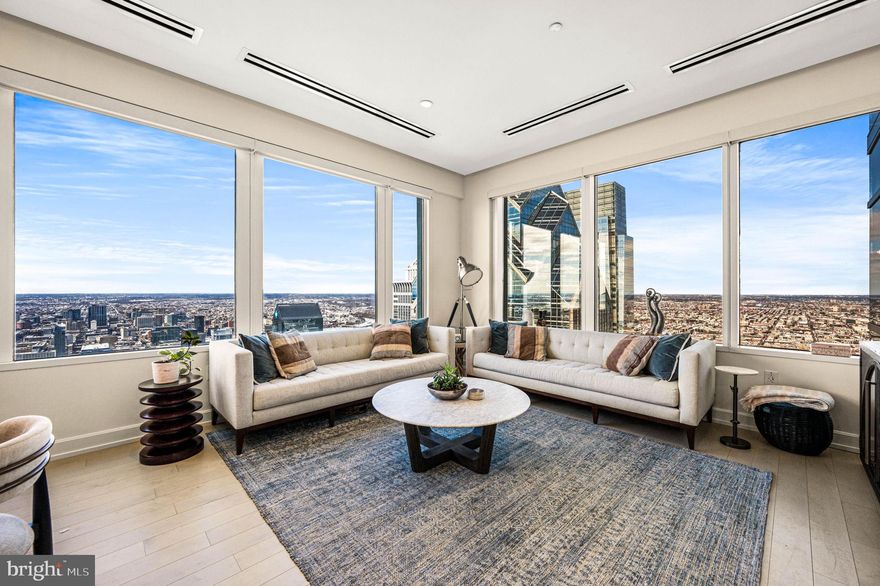 Elevated living reaches new heights on the 52nd floor of Two Liberty, a premier full-service luxury condominium in the heart of Center City. Residence #5203 offers breathtaking panoramic views with sweeping north-west  exposures framed by expansive walls of glass  placing you high above the city while just steps from Rittenhouse Square and Philadelphia’s finest dining, shopping, and cultural destinations.   Spanning approximately 1,140 square feet, this two-bedroom, two-bath home is designed to showcase the city at every turn. The open living and dining areas are flooded with natural light from sunrise through sunset, creating an airy, sophisticated atmosphere high above it all.  The elegant kitchen features quartz countertops, abundant cabinetry, a SubZero refrigerator, Miele dishwasher, newly installed Miele oven, and Thermador microwave.   The primary suite offers custom closets and a marble bath with double vanity, soaking tub, and an oversized glass-enclosed shower. The second bedroom has been enhanced with a custom built-in wall system and beverage refrigerator, making it ideal as a guest suite or office.  A second full marble bath with walk-in shower is conveniently located just outside the room.  Additional features include wide-plank maple flooring, Hunter Douglas window treatments, custom closet cabinetry, new Bosch washer and dryer, chandeliers in both bedrooms, updated HVAC actuators and thermostats,  and TWO storage units.
Residents enjoy true full-service living with 24-hour concierge, chauffeur-driven town car service, and access to the fully  renovated 37th-floor amenity level complete with state-of-the-art fitness center, endless pool, yoga studio, saunas, massage room, conference rooms, resident lounge with fireplace and billiards, and an extraordinary entertaining kitchen overlooking spectacular city views.  Valet parking is available for an additional fee.  Live elevated. Live effortlessly. Live at Two Liberty.