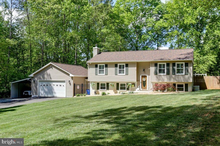 Beautiful wooded 1 acre lot with the most serene of settings.  Exquisite curb appeal beckons you to enter.  The well-maintained interior features large formal living room with wood floors and pocket French doors separating the living room from the kitchen/dining combination.  The gourmet kitchen has ample, upgraded cabinetry, granite counters and stainless steel appliances; ceramic tile flooring makes for easy cleaning.  Sliding glass door from dining area leads to premium 20x12 Yardistry gazebo on the enormous deck, with sunshade and lighted stairs to grade.  There is open deck for sun-lovers!  The primary bedroom has sitting room, that can be easily converted back into a bedroom, as well as sliding glass door to the rear deck.  The second bedroom is perfect for use as home office too.  The primary bathroom has room for two, with oversized vanity, shower stall & new skylight with remote controlled shade.  There are attractive window plantation shutters to provide privacy.<br><br>  Downstairs is an informal family room, remodeled in 2024, and features beautiful LVP flooring.  Central to the room is the fireplace with wood stove insert, sure to keep you warm on chilly nights.  There is a third bedroom with carpeting on the lower level as well as a full bath (complete with jetted tub).  Laundry day is easy with the front load, full size clothes washer and clothes dryer, storage cabinets and utility sink.  Need to get to the garage or the backyard?  Service door opens at grade to covered portico to garage service door.  Fenced backyard is perfect for pets or kids.  There is garden gravel off deck ... a great place to set up corn hole or above-ground pool. <br><br>The car enthusiast and/or hobbyist will LOVE the attached 24x30 garage!  (Polyaspartic floor coating, mini-split heating & cooling & separate water heater.)  In the backyard, you have access to a 20x20 metal shed, which has service door along with overhead door and a concrete floor.  There is a second shed, for storing garden tools, sports supplies or use as a she-shed. <br><br> Much TLC has been given to the house since 2018.  Brand new roof & water heater (2026)!  Window replacement & kitchen sliding glass door.  Trex deck.  Water filtration system with UV light.  Ready for whole house generator.  The list goes on!